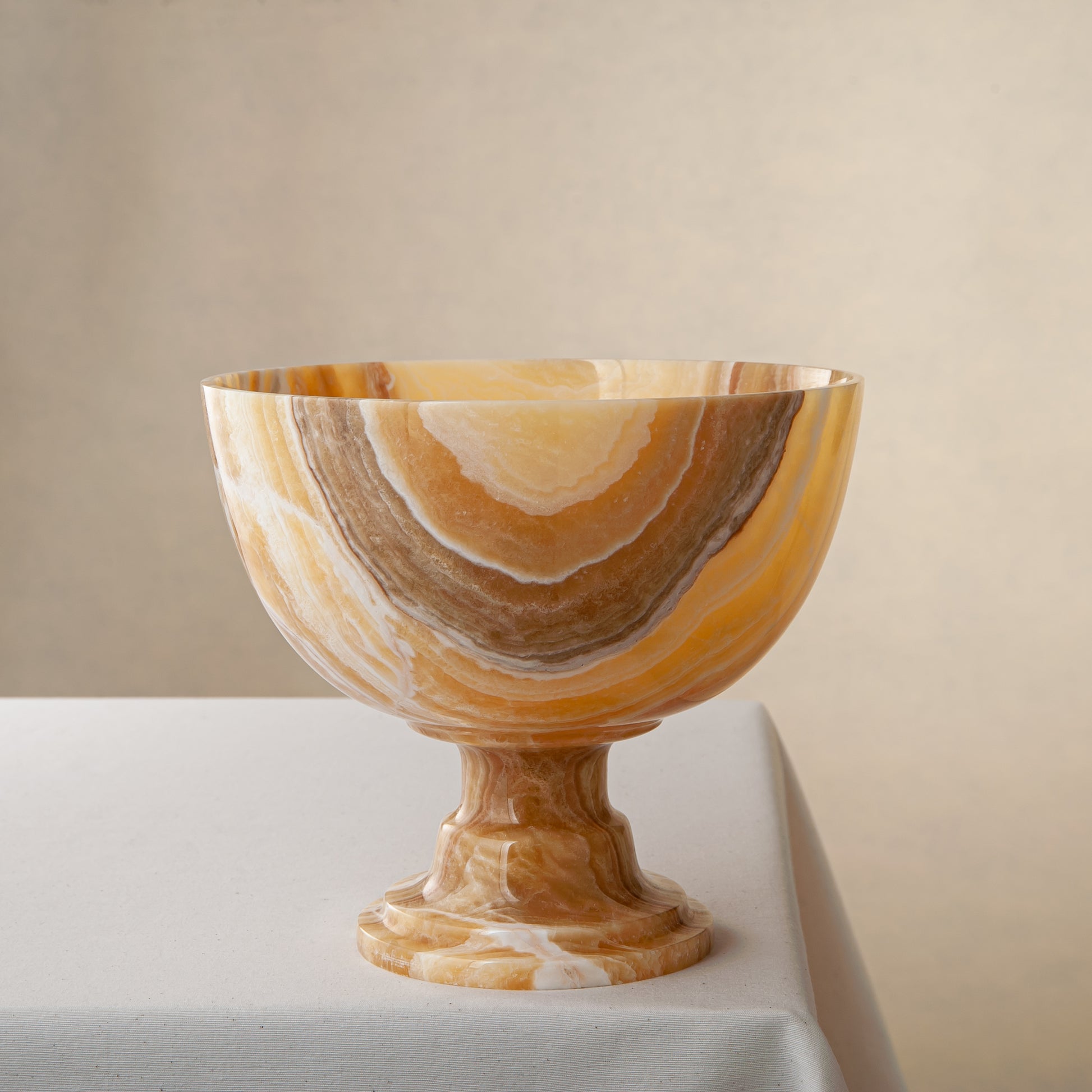 handcrafted onyx bowl with pedestal base and striking circular veining for table decor