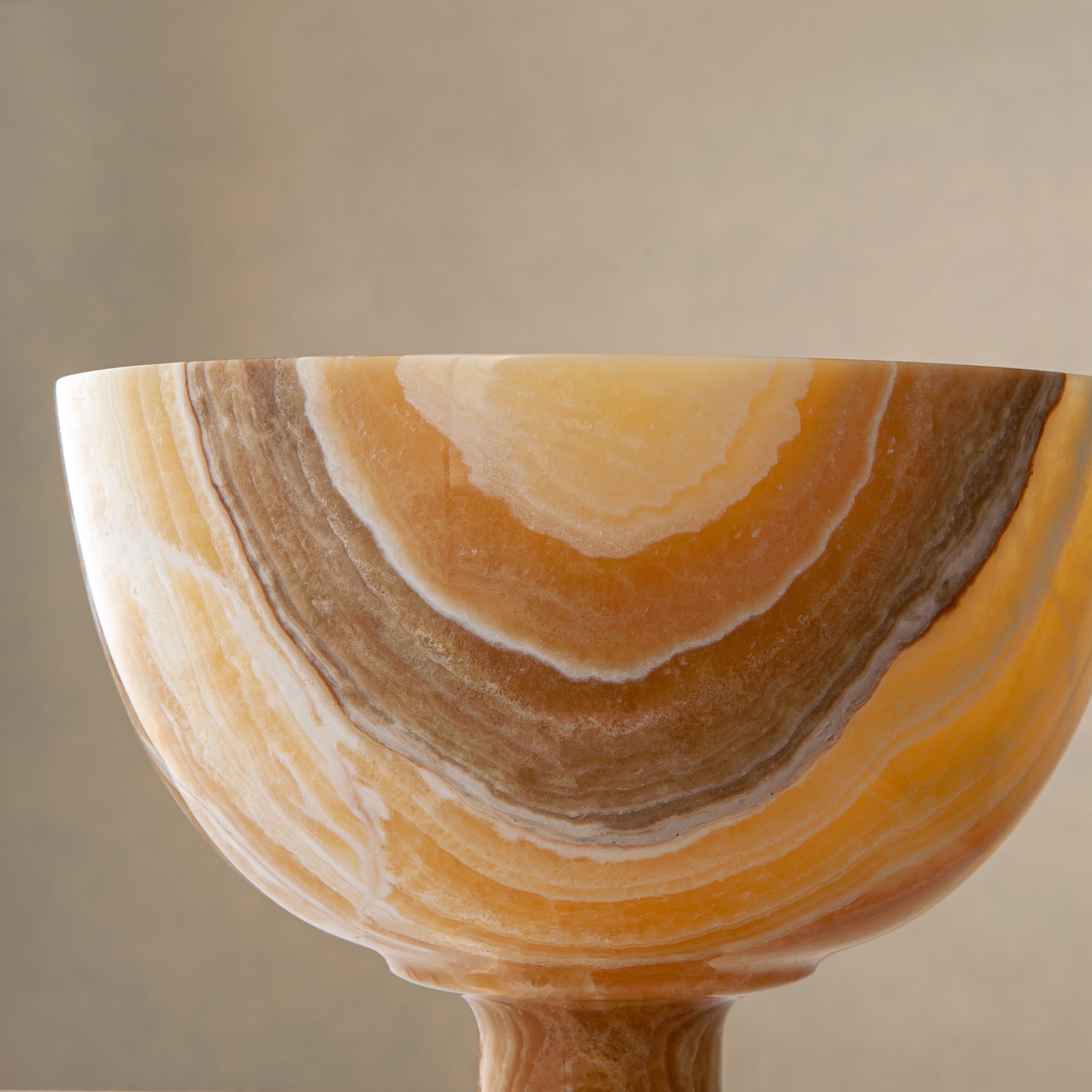 handcrafted onyx bowl with pedestal base and striking circular veining for table decor