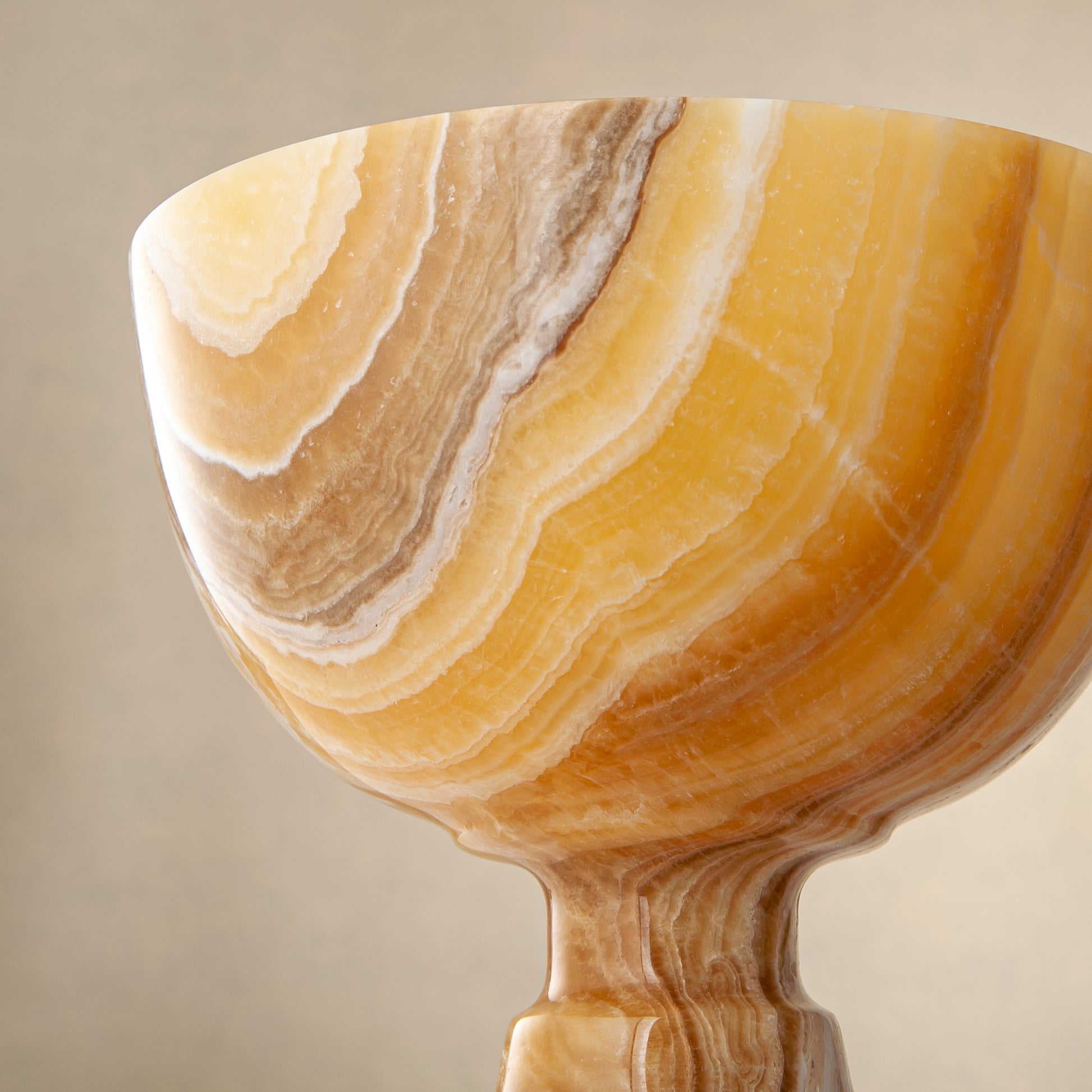 handcrafted onyx bowl with pedestal base and striking circular veining for table decor