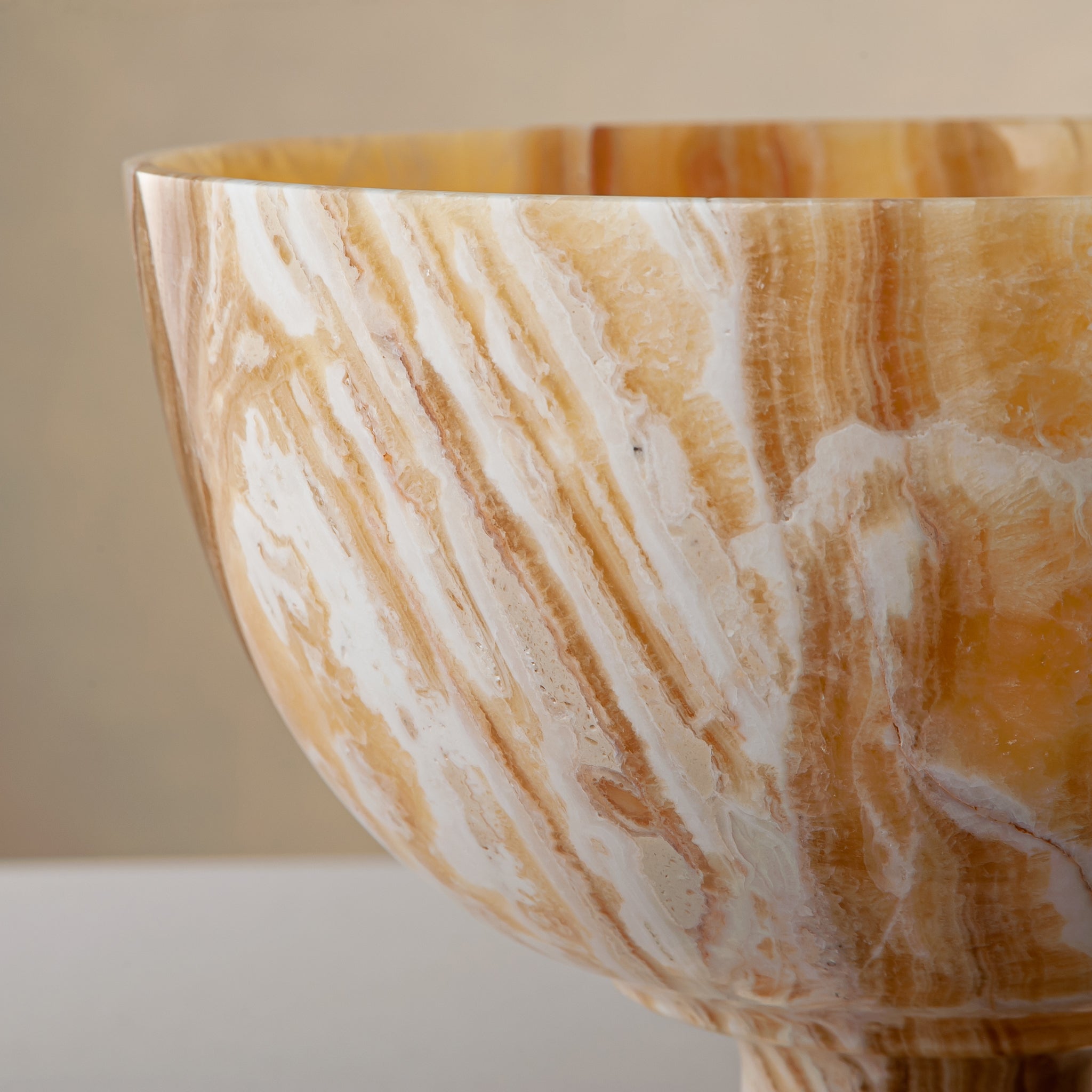 handcrafted onyx bowl with pedestal base and striking circular veining for table decor