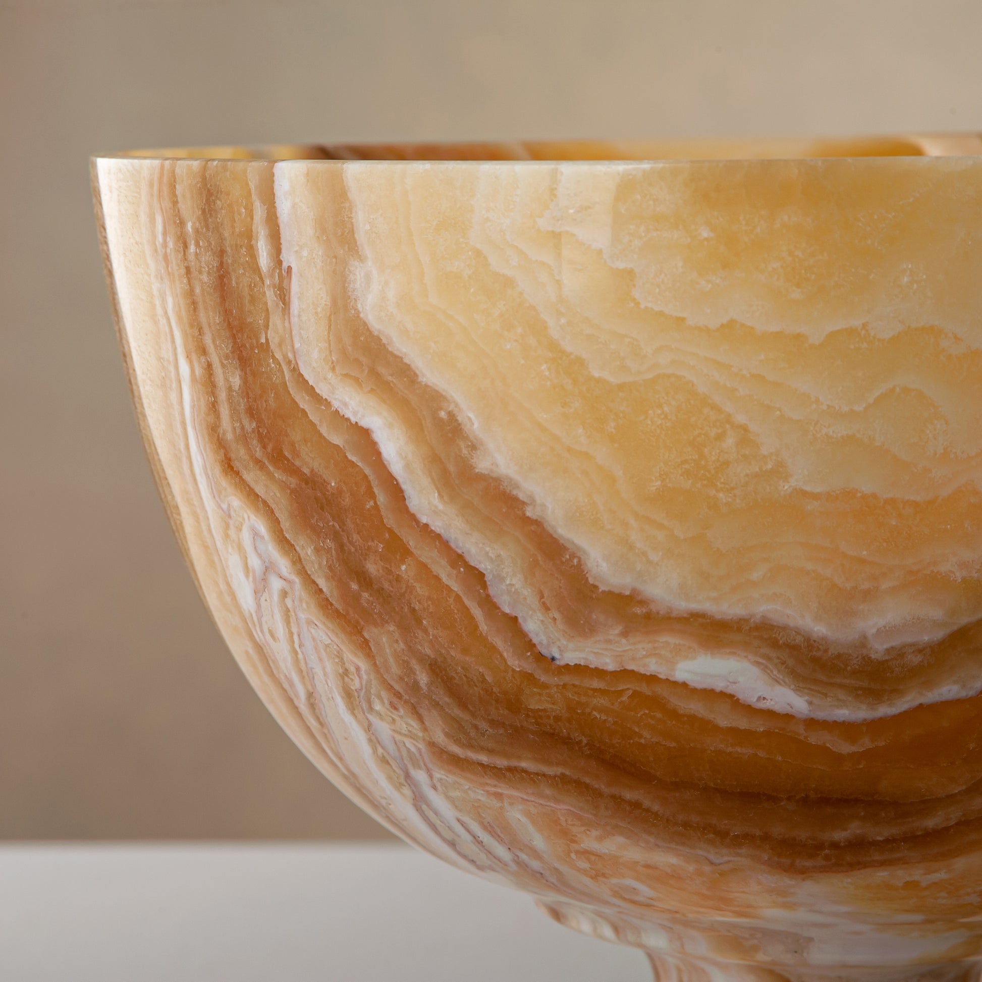 handcrafted onyx bowl with pedestal base and striking circular veining for table decor