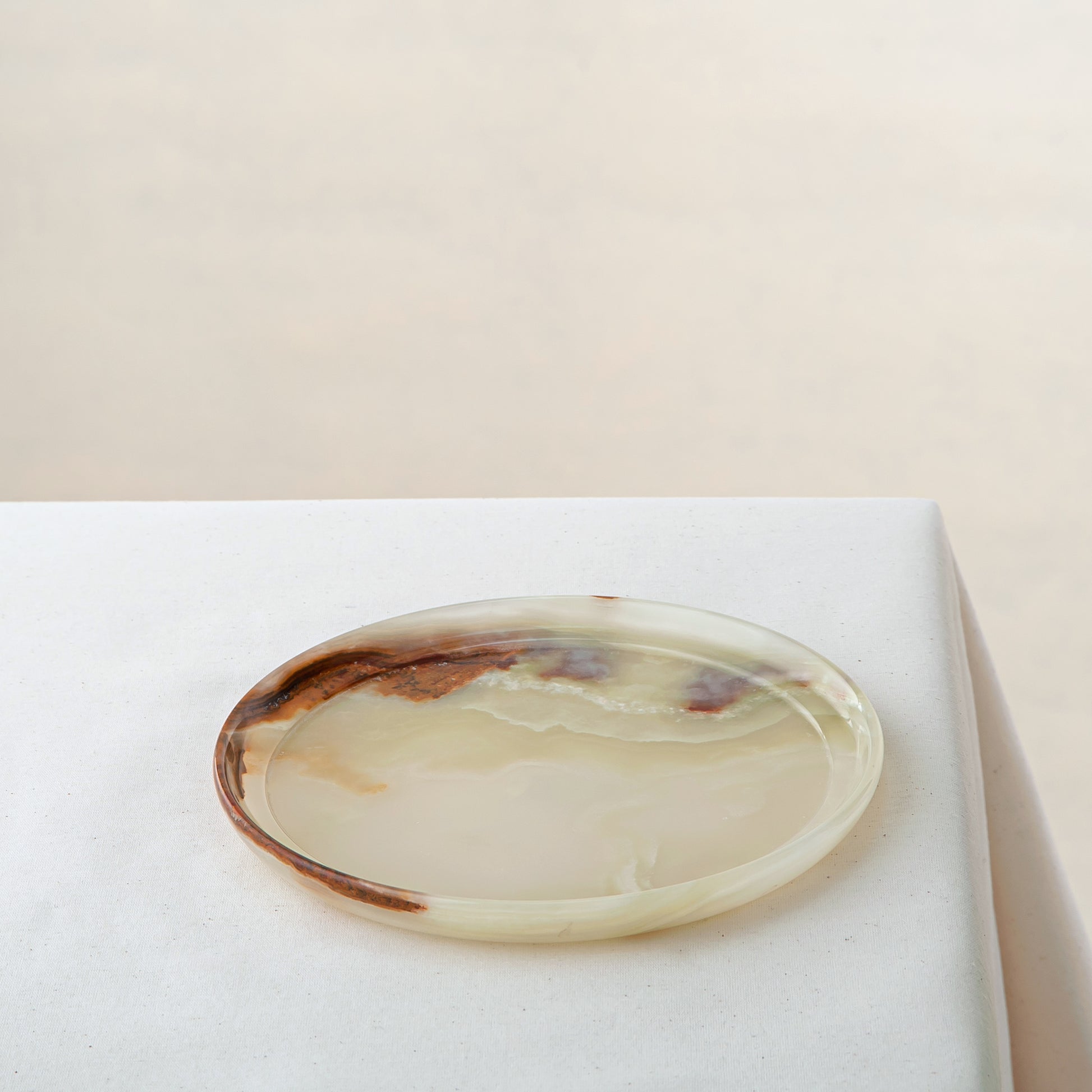handcrafted onyx plate with translucent ivory tones and warm amber veining for luxury table decor
