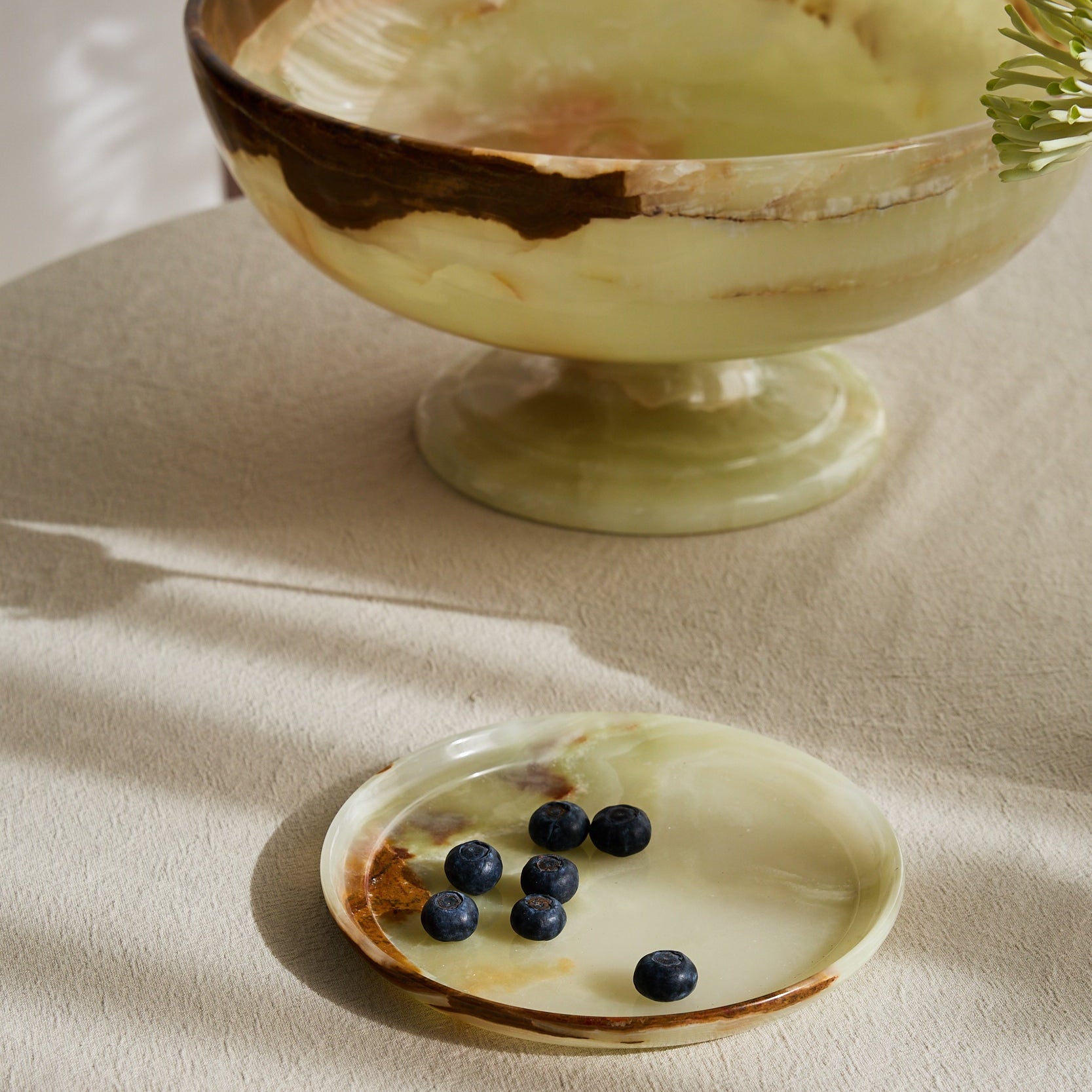 handcrafted onyx plate with translucent ivory tones and warm amber veining for luxury table decor
