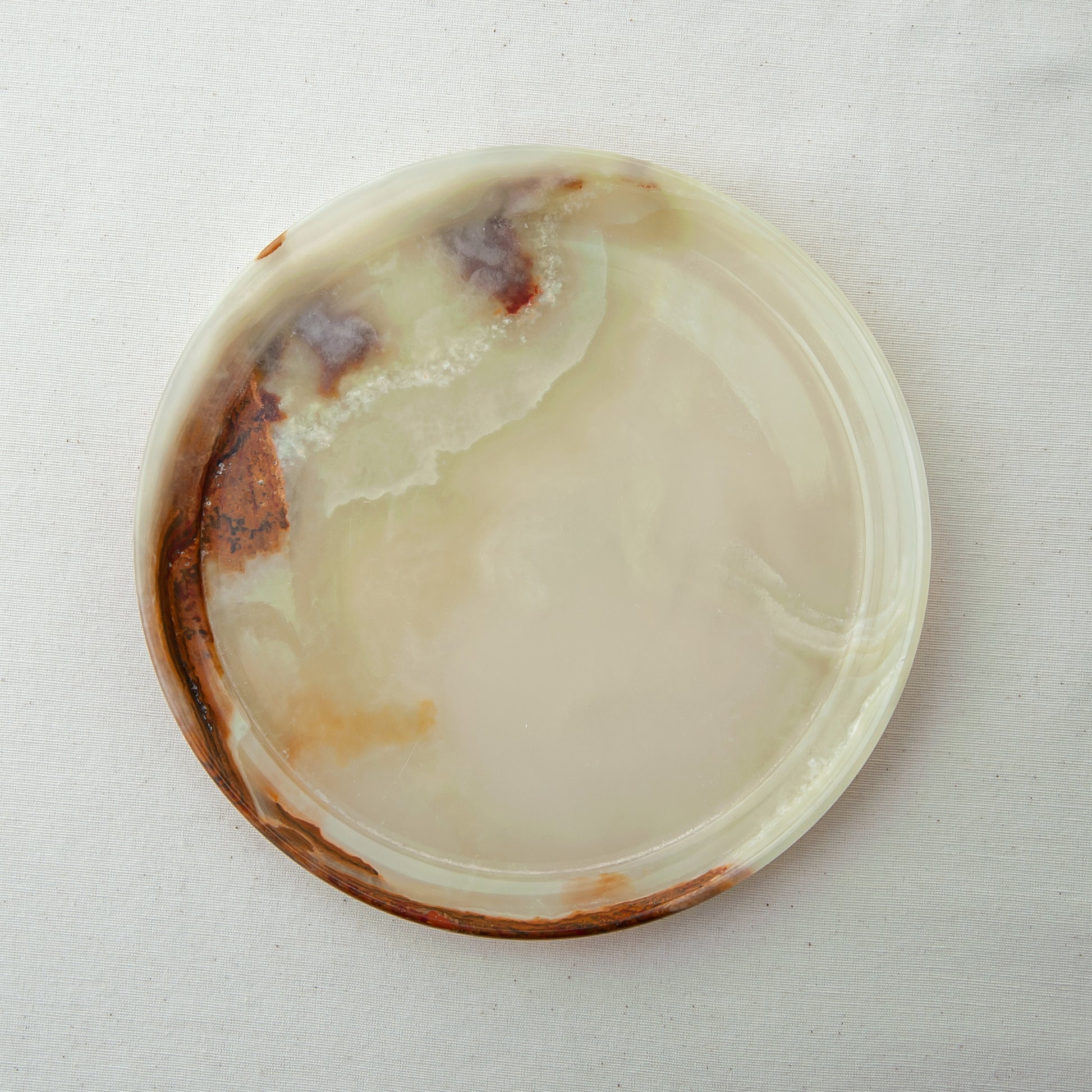 handcrafted onyx plate with translucent ivory tones and warm amber veining for luxury table decor