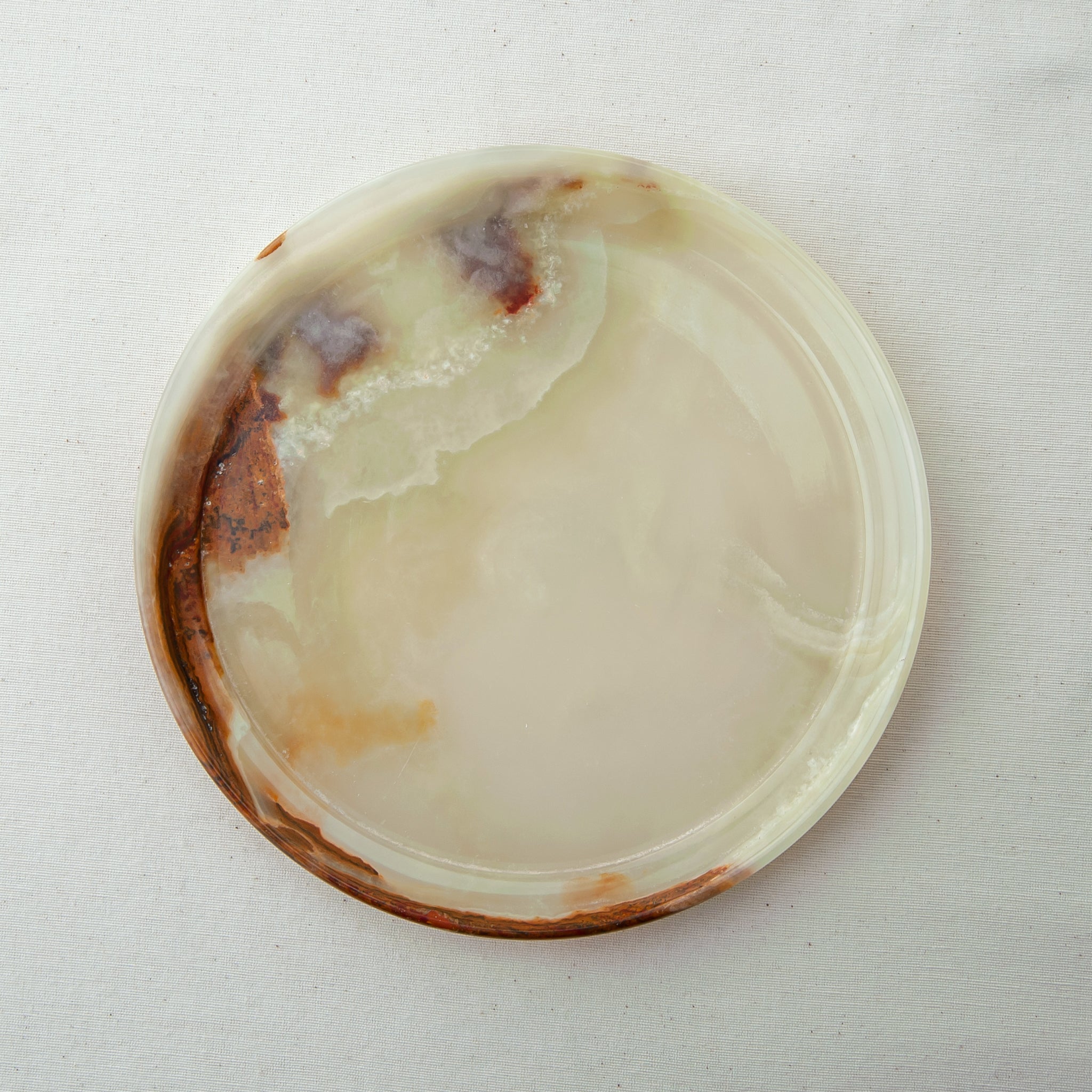 handcrafted onyx plate with translucent ivory tones and warm amber veining for luxury table decor