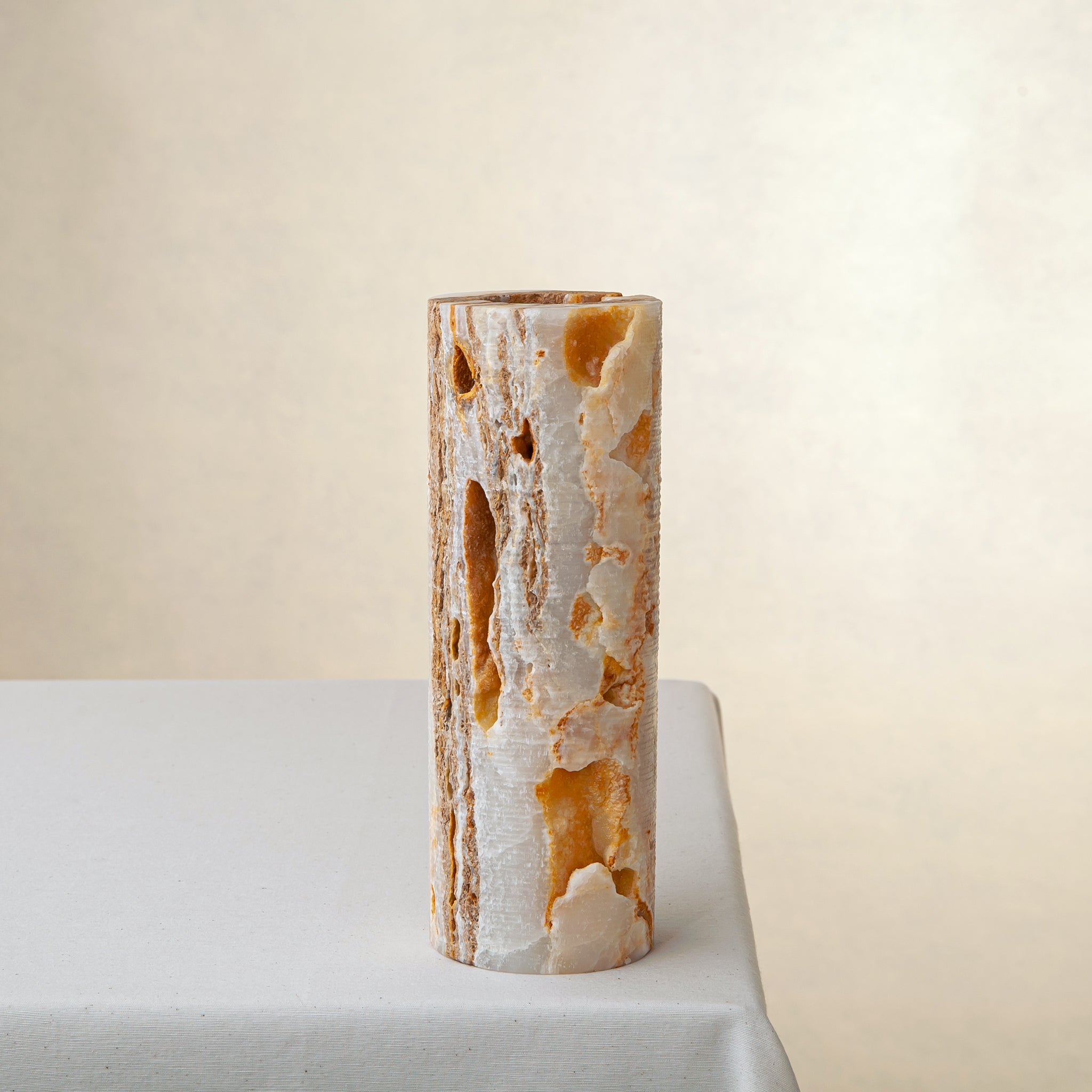 handcrafted onyx vase with warm amber veining and natural cavities for luxury interior decor
