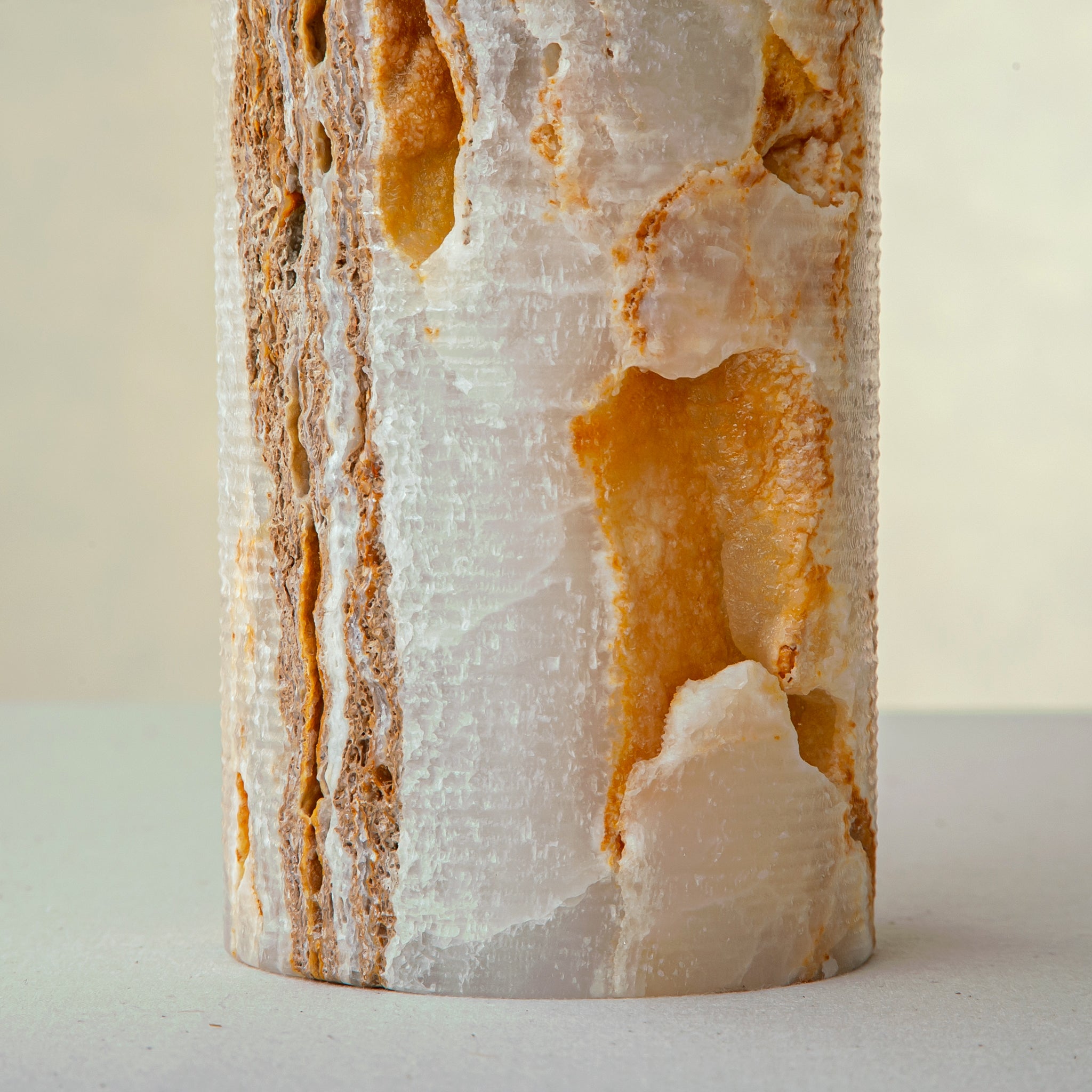 handcrafted onyx vase with warm amber veining and natural cavities for luxury interior decor
