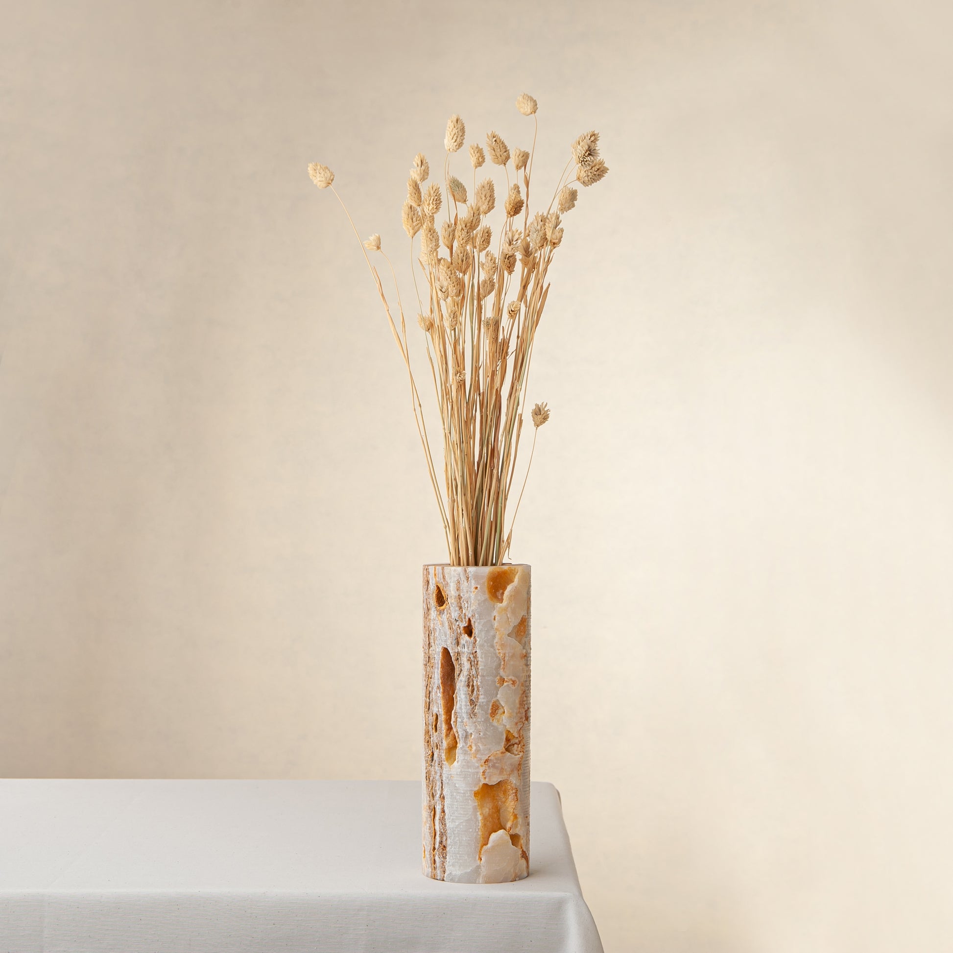 handcrafted onyx vase with warm amber veining and natural cavities for luxury interior decor
