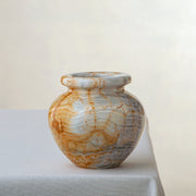 Handcrafted onyx vase with layered ivory and amber veining sculptural decor
