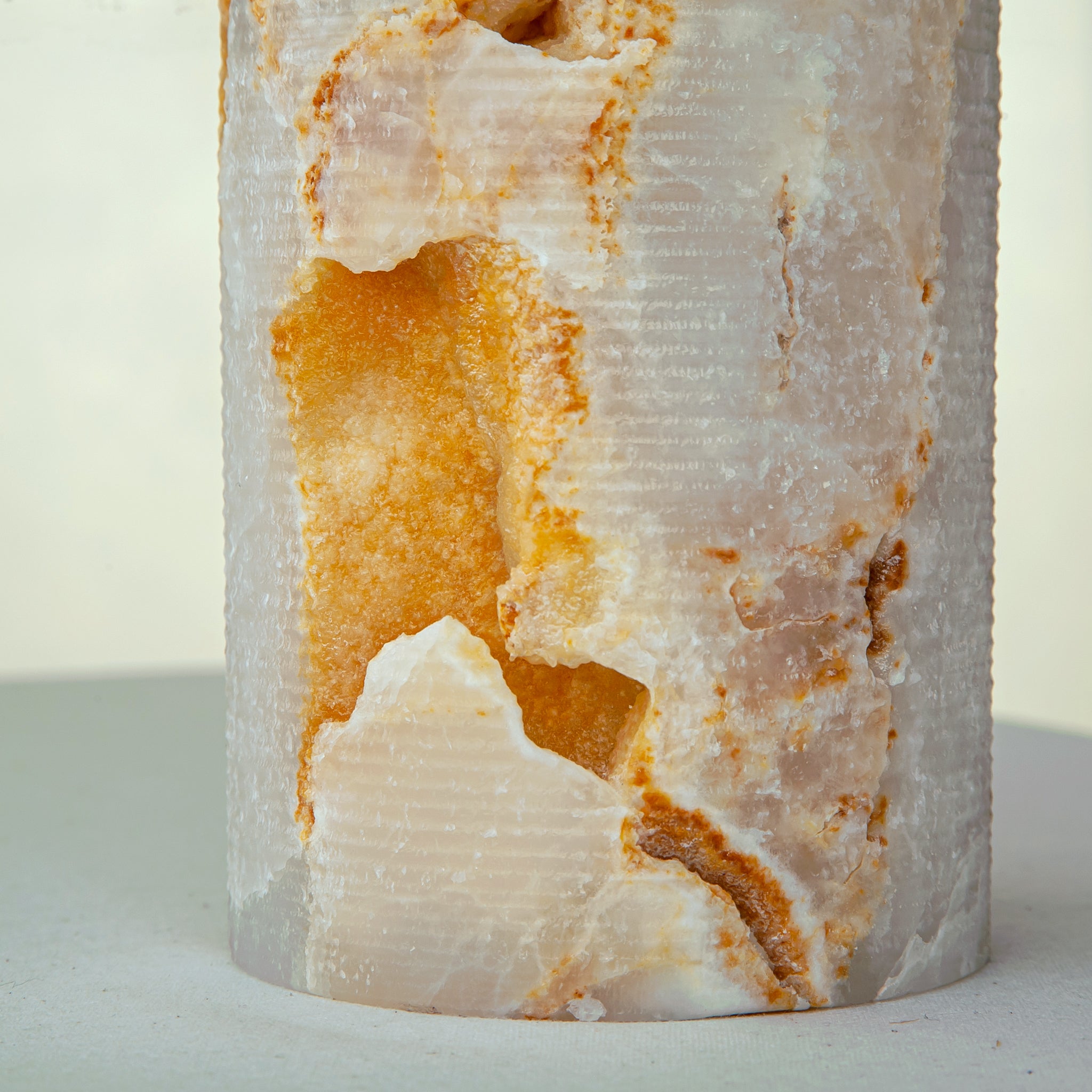 handcrafted onyx vase with warm amber veining and natural cavities for luxury interior decor
