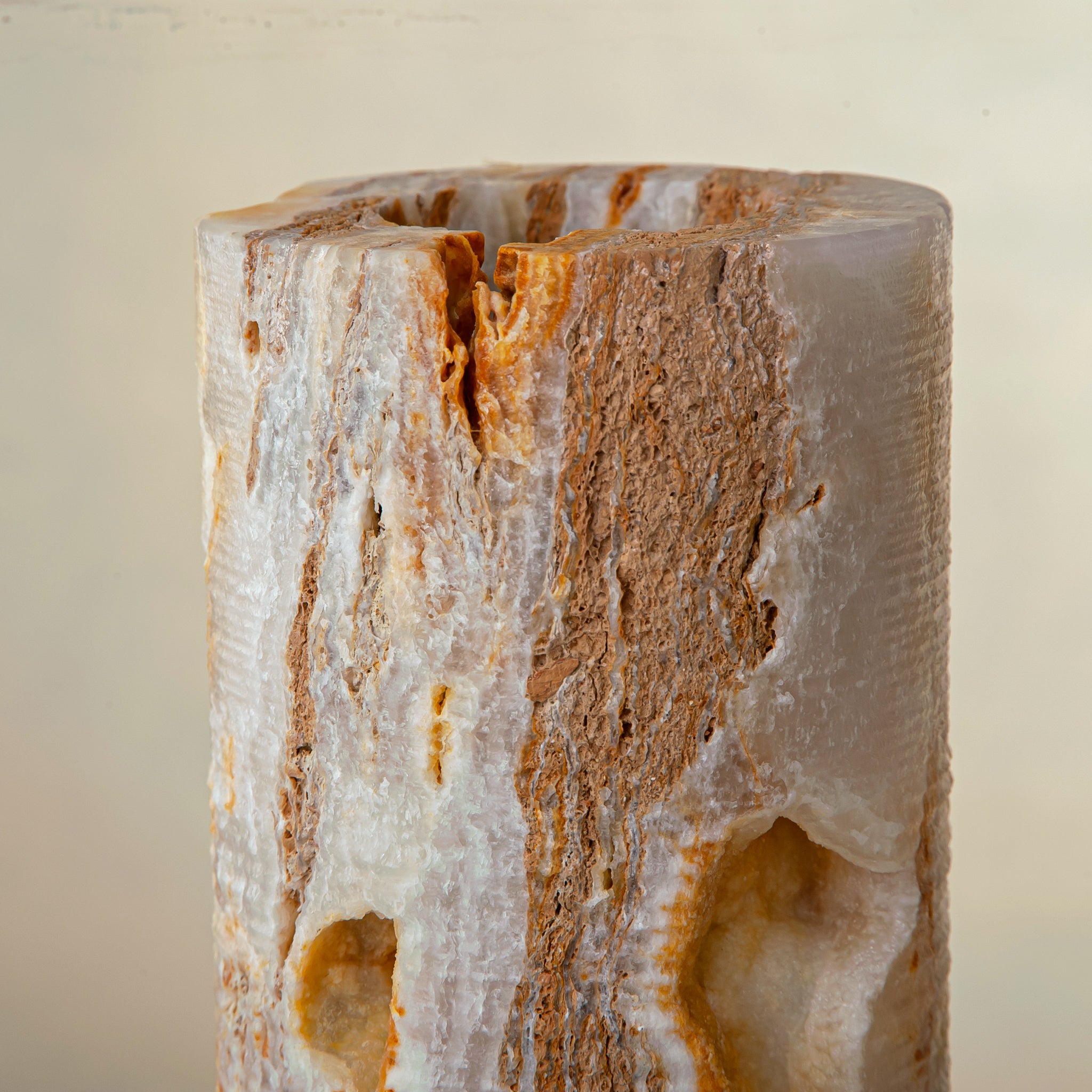 handcrafted onyx vase with warm amber veining and natural cavities for luxury interior decor
