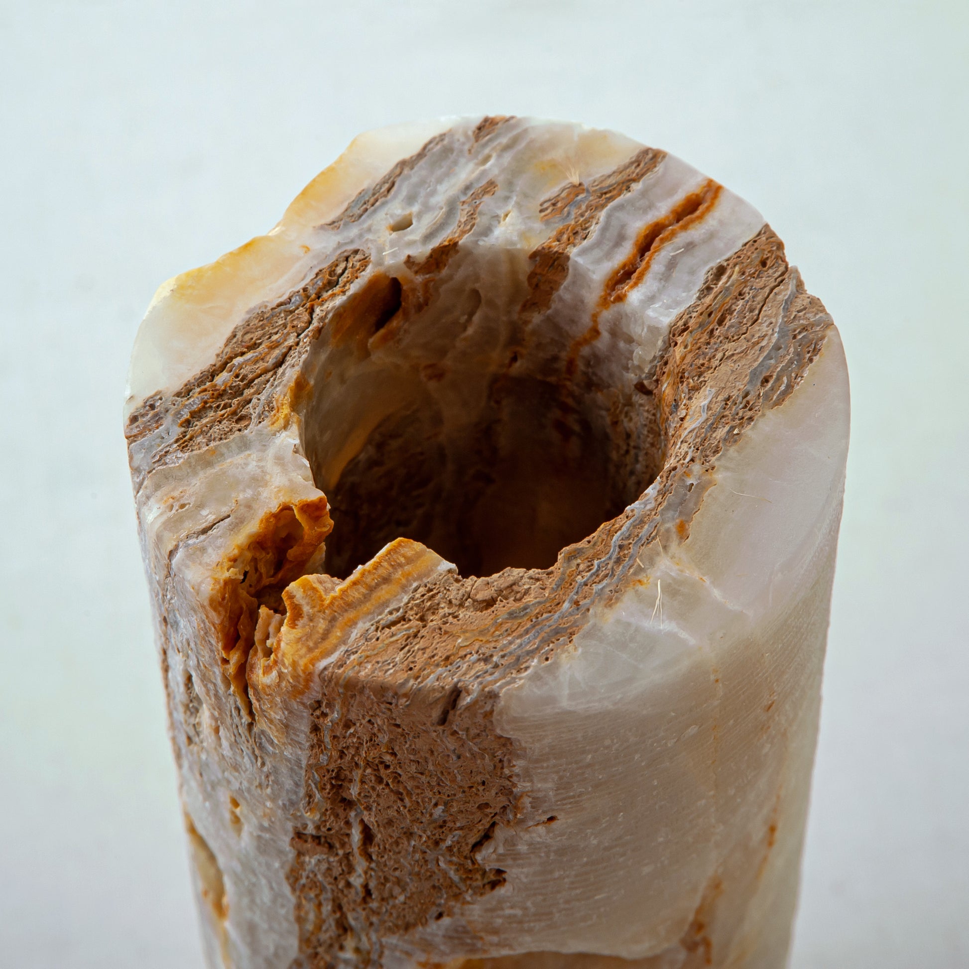 handcrafted onyx vase with warm amber veining and natural cavities for luxury interior decor
