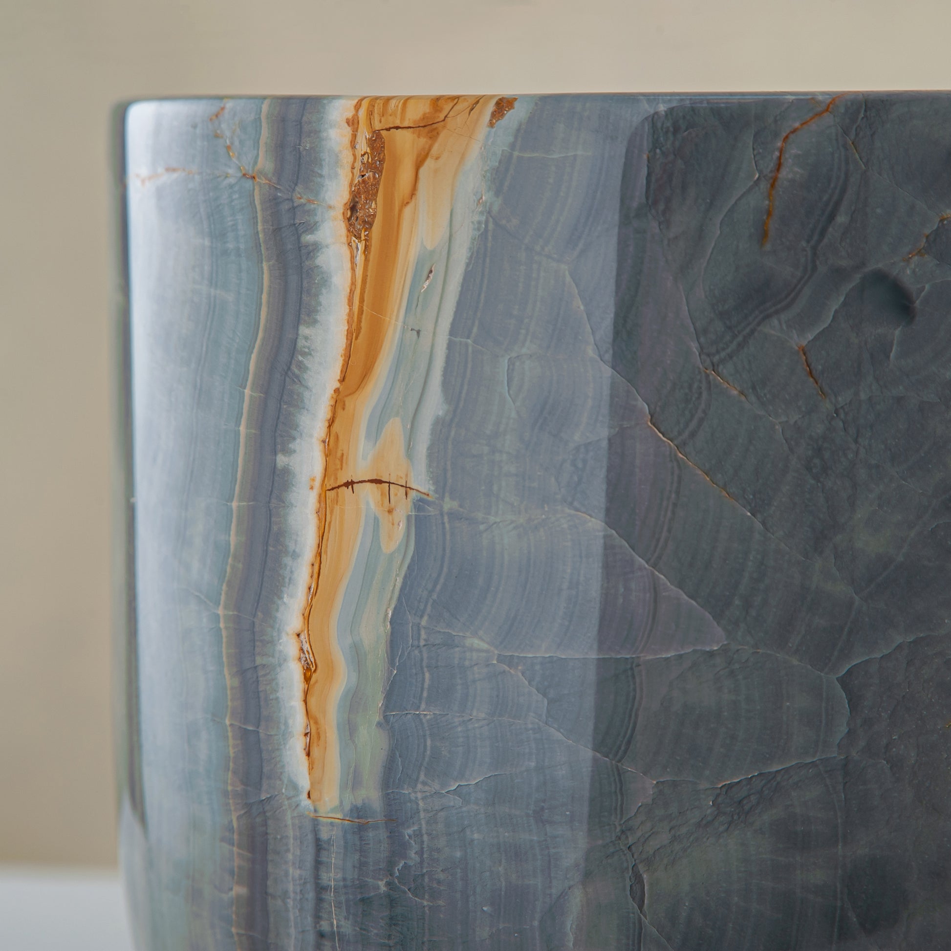 handcrafted onyx vase in blue grey stone with amber veining as a luxury centerpiece
