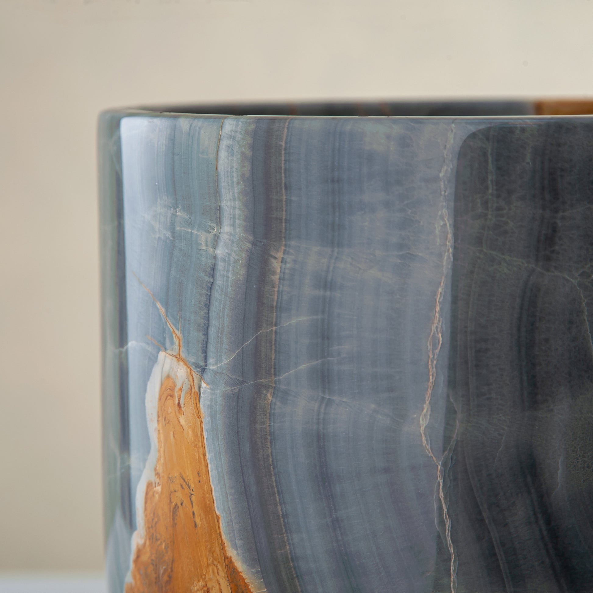 handcrafted onyx vase in blue grey stone with amber veining as a luxury centerpiece
