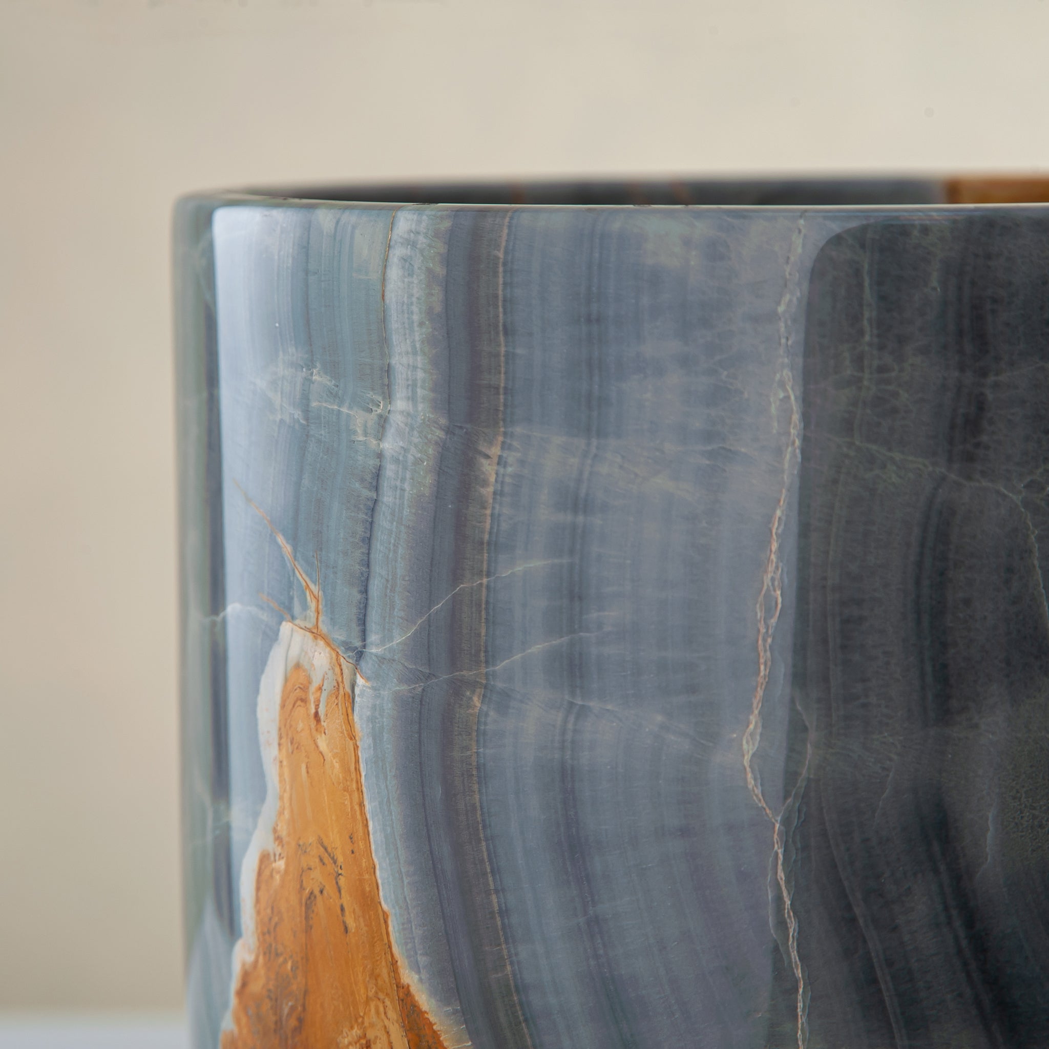handcrafted onyx vase in blue grey stone with amber veining as a luxury centerpiece
