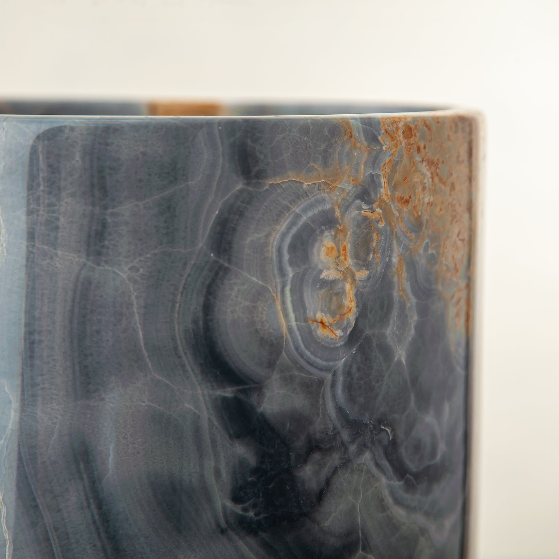 handcrafted onyx vase in blue grey stone with amber veining as a luxury centerpiece
