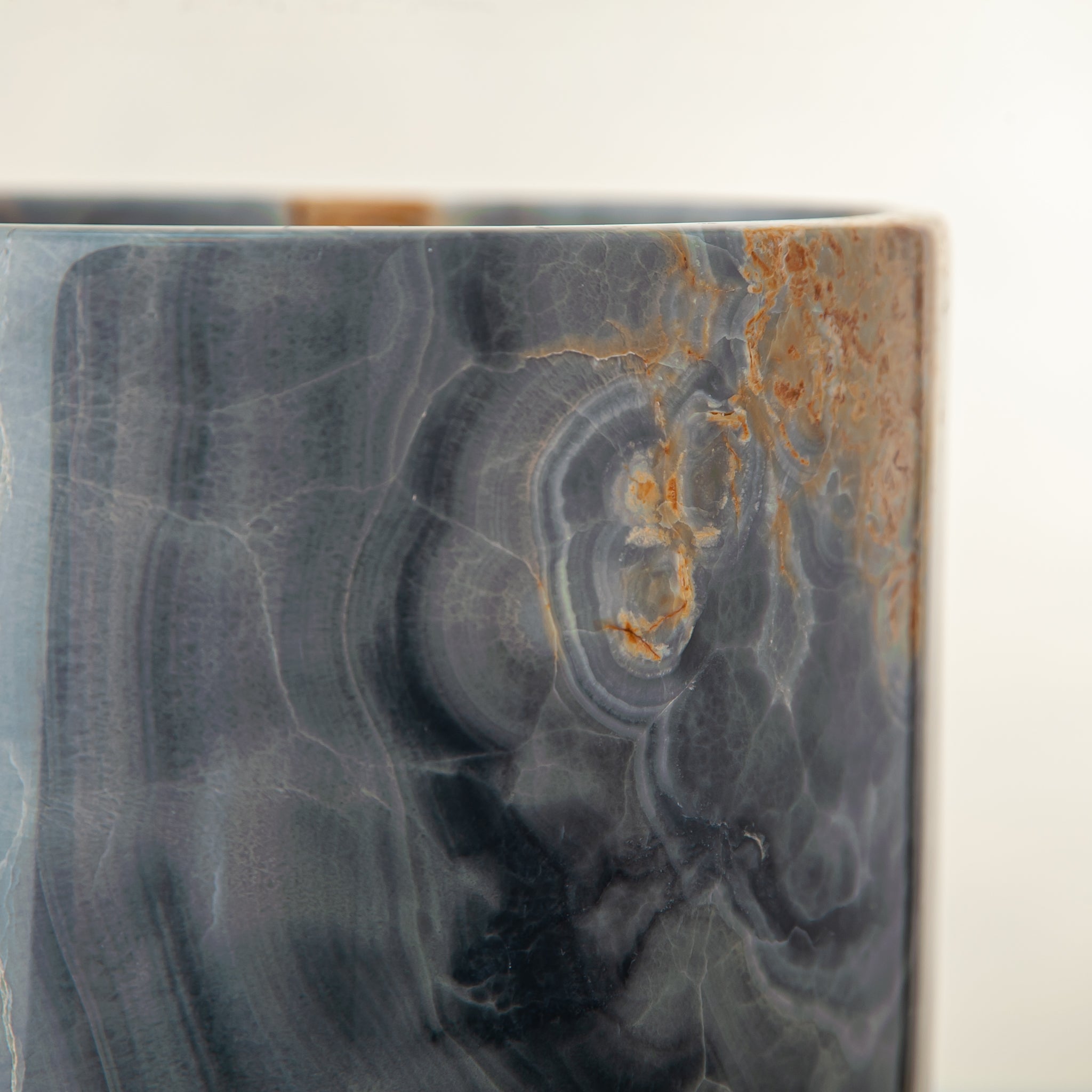 handcrafted onyx vase in blue grey stone with amber veining as a luxury centerpiece
