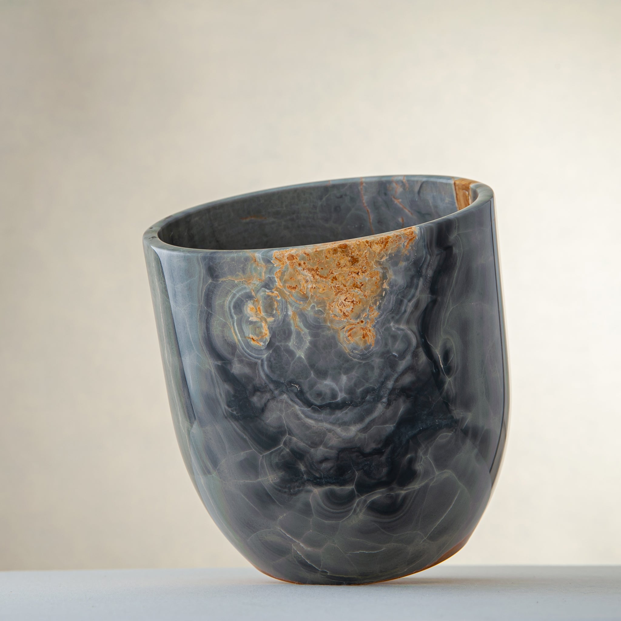 handcrafted onyx vase in blue grey stone with amber veining as a luxury centerpiece
