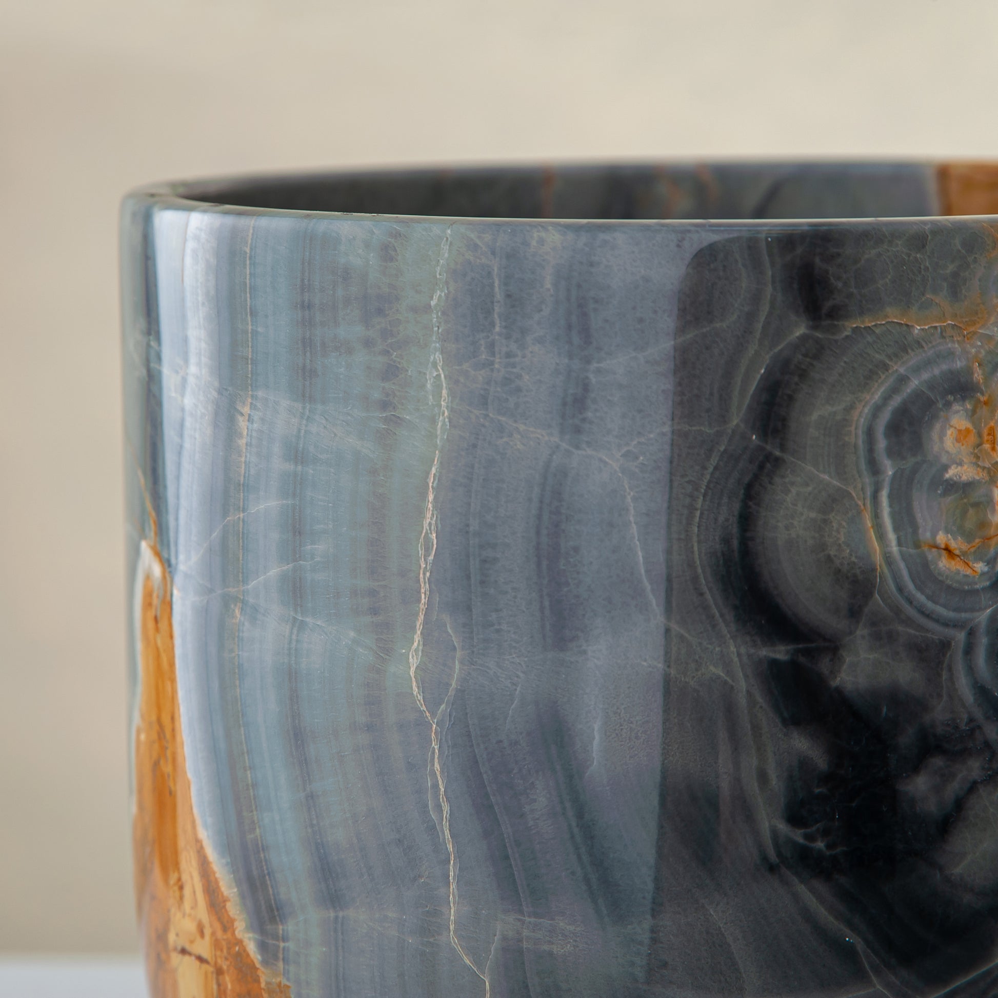 handcrafted onyx vase in blue grey stone with amber veining as a luxury centerpiece

