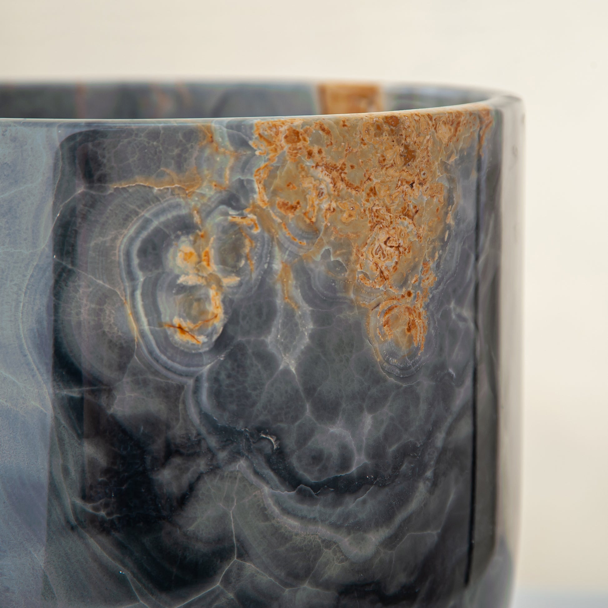 handcrafted onyx vase in blue grey stone with amber veining as a luxury centerpiece
