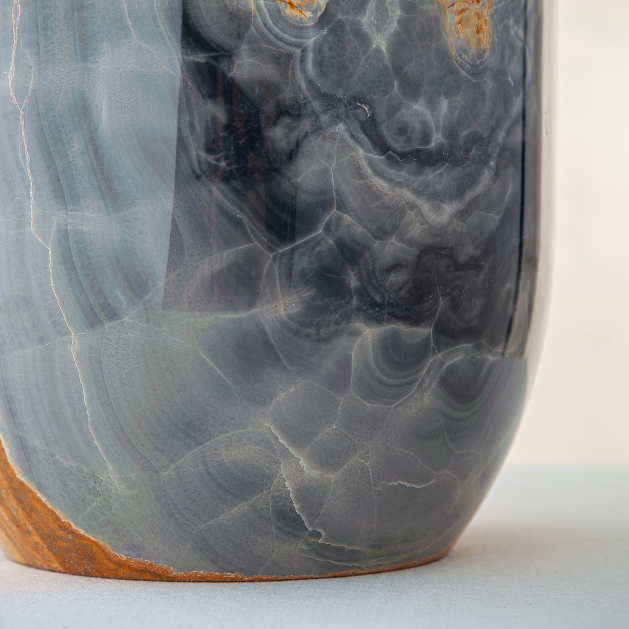 handcrafted onyx vase in blue grey stone with amber veining as a luxury centerpiece

