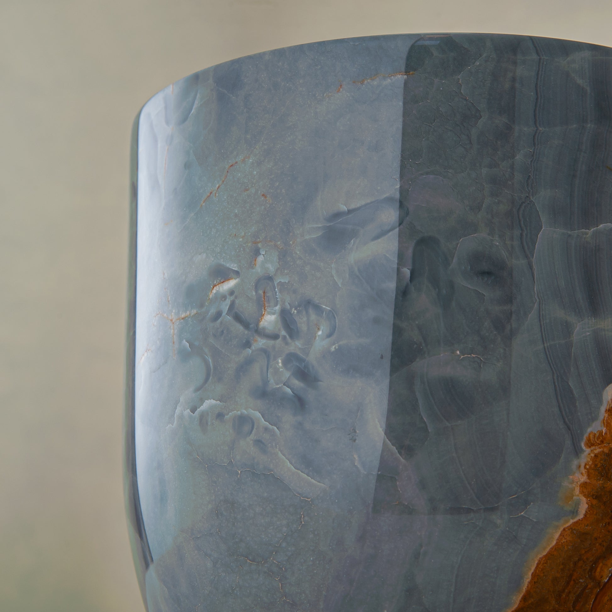 handcrafted onyx vase in blue grey stone with amber veining as a luxury centerpiece
