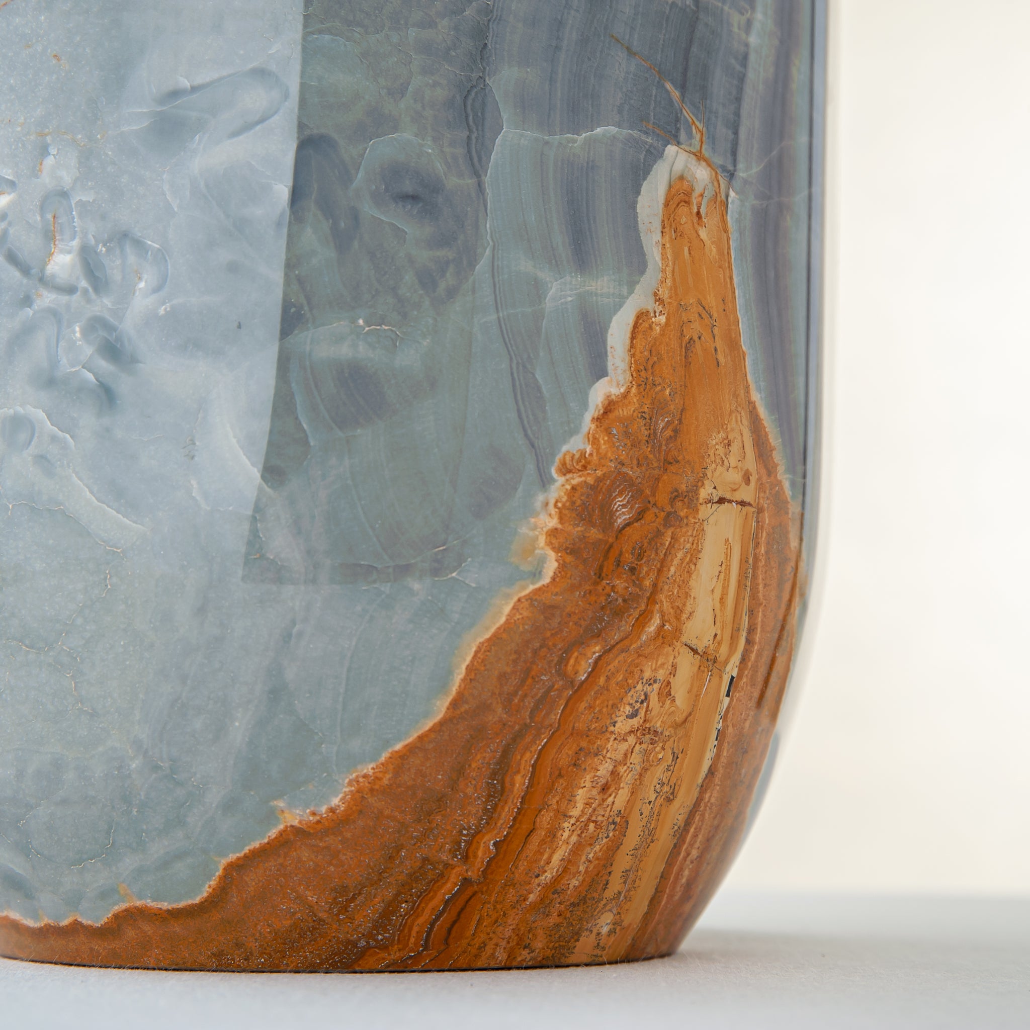 handcrafted onyx vase in blue grey stone with amber veining as a luxury centerpiece
