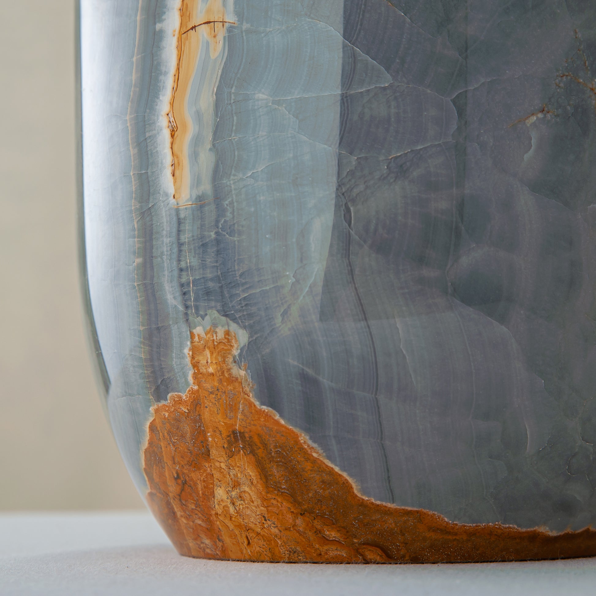 handcrafted onyx vase in blue grey stone with amber veining as a luxury centerpiece
