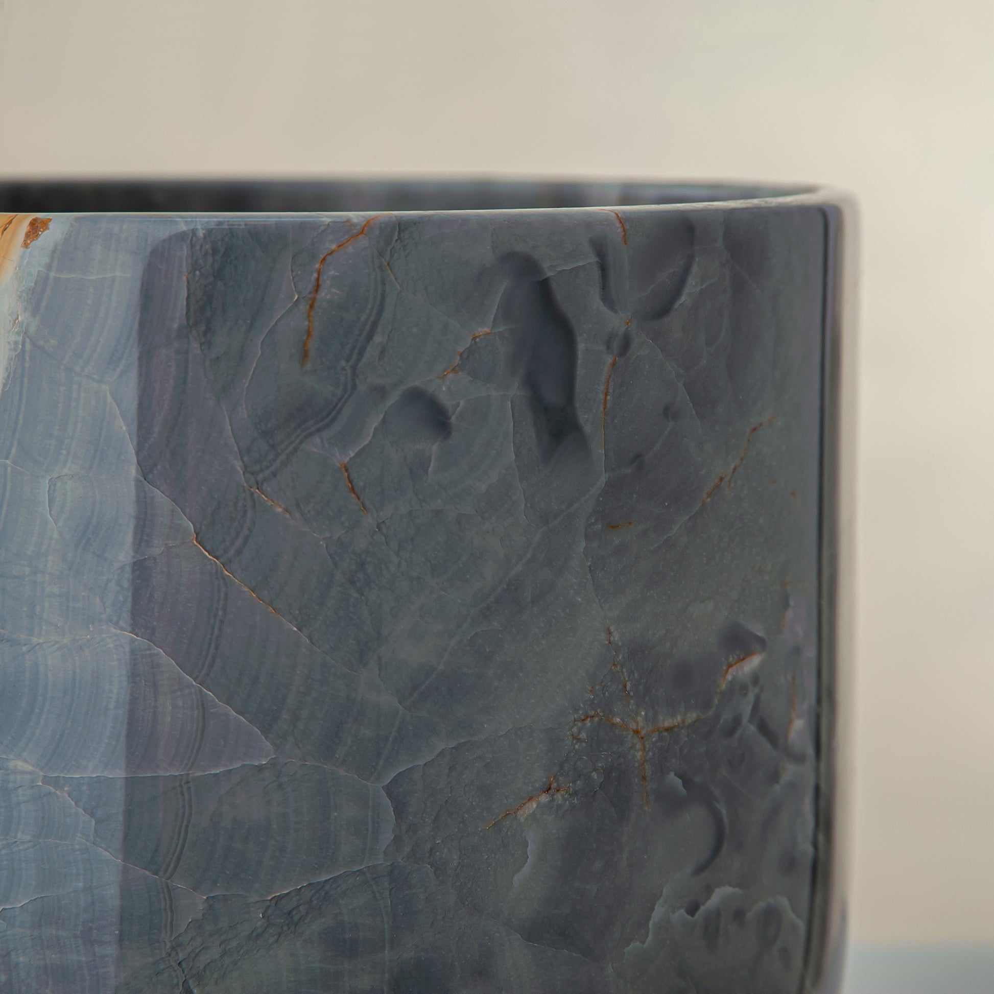 handcrafted onyx vase in blue grey stone with amber veining as a luxury centerpiece

