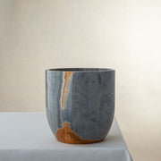 handcrafted onyx vase in blue grey stone with amber veining as a luxury centerpiece
