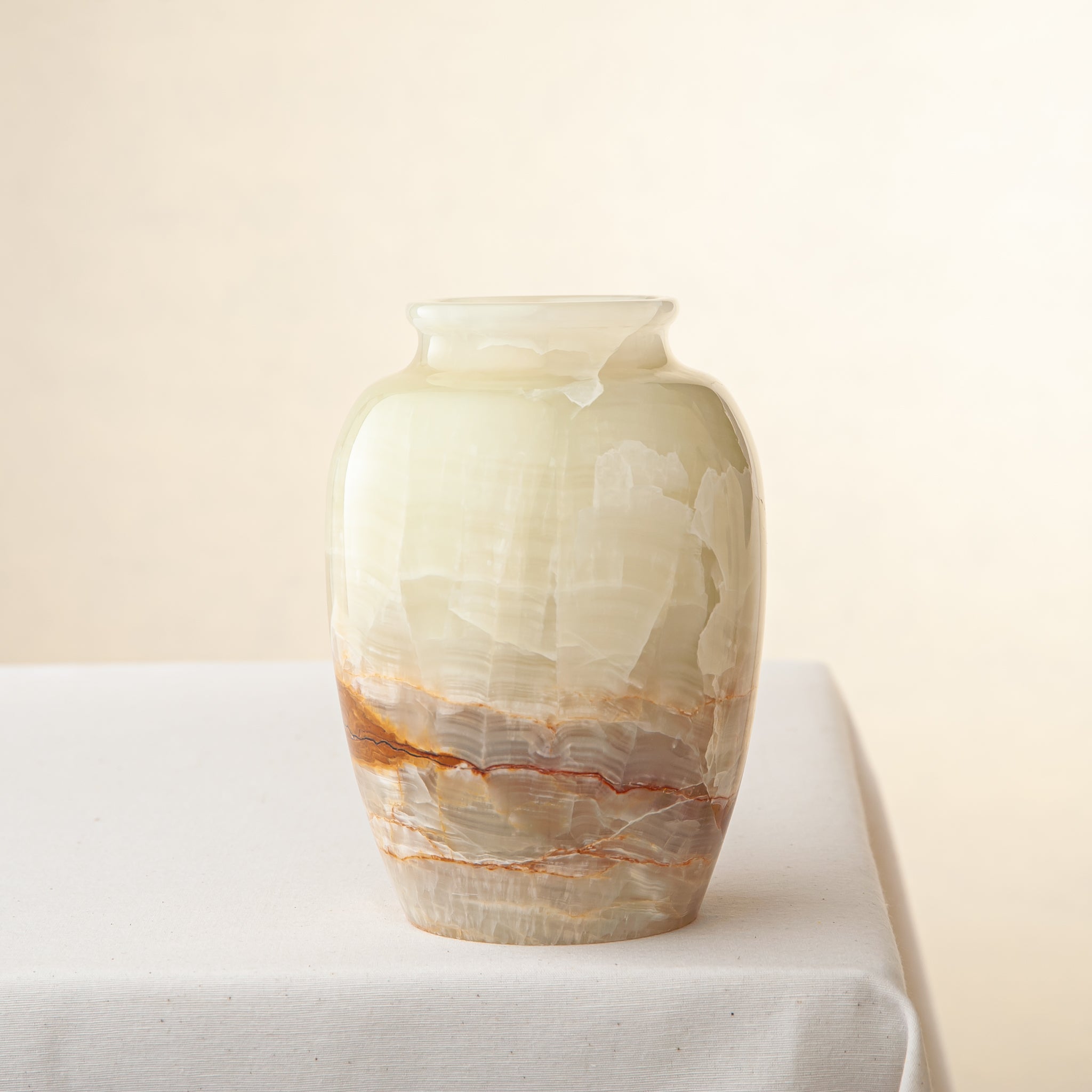 handcrafted onyx vase in ivory tones with warm amber veining for elegant decor
