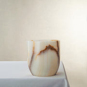 handcrafted onyx vase with ivory base and bold brown veining for modern decor

