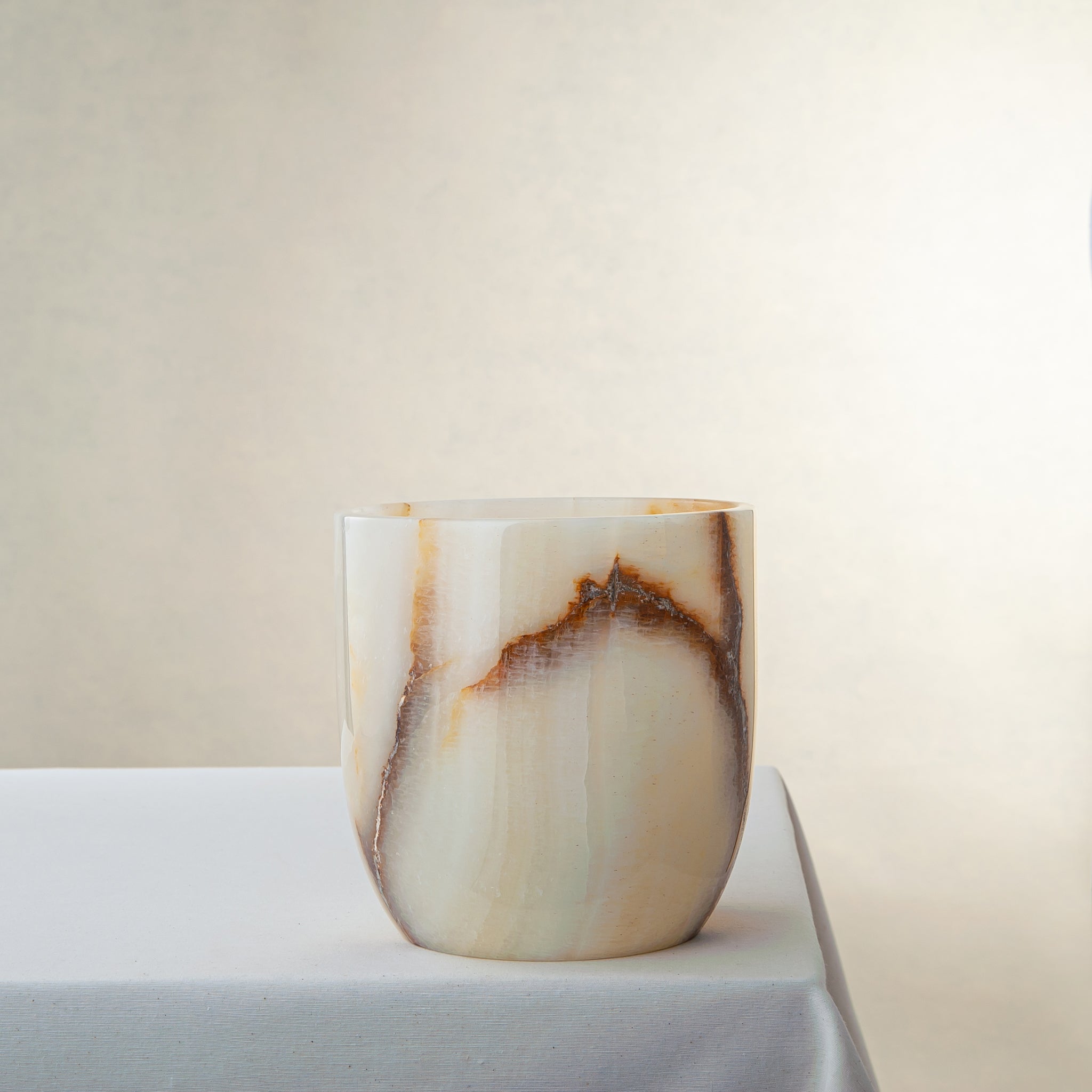 handcrafted onyx vase with ivory base and bold brown veining for modern decor
