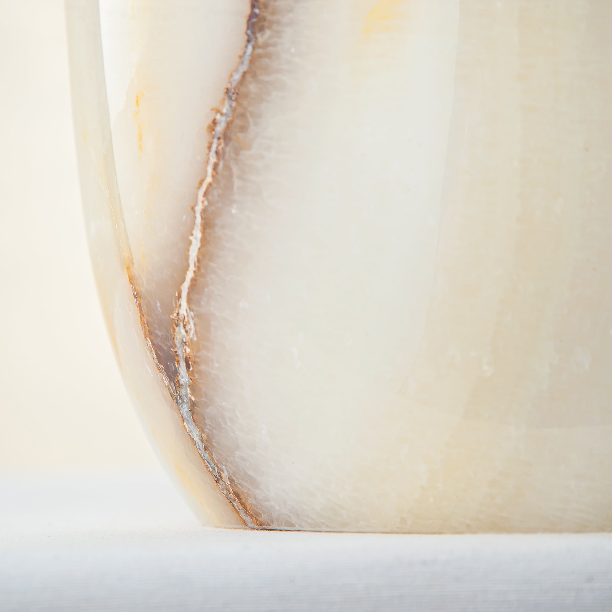 handcrafted onyx vase with ivory base and bold brown veining for modern decor
