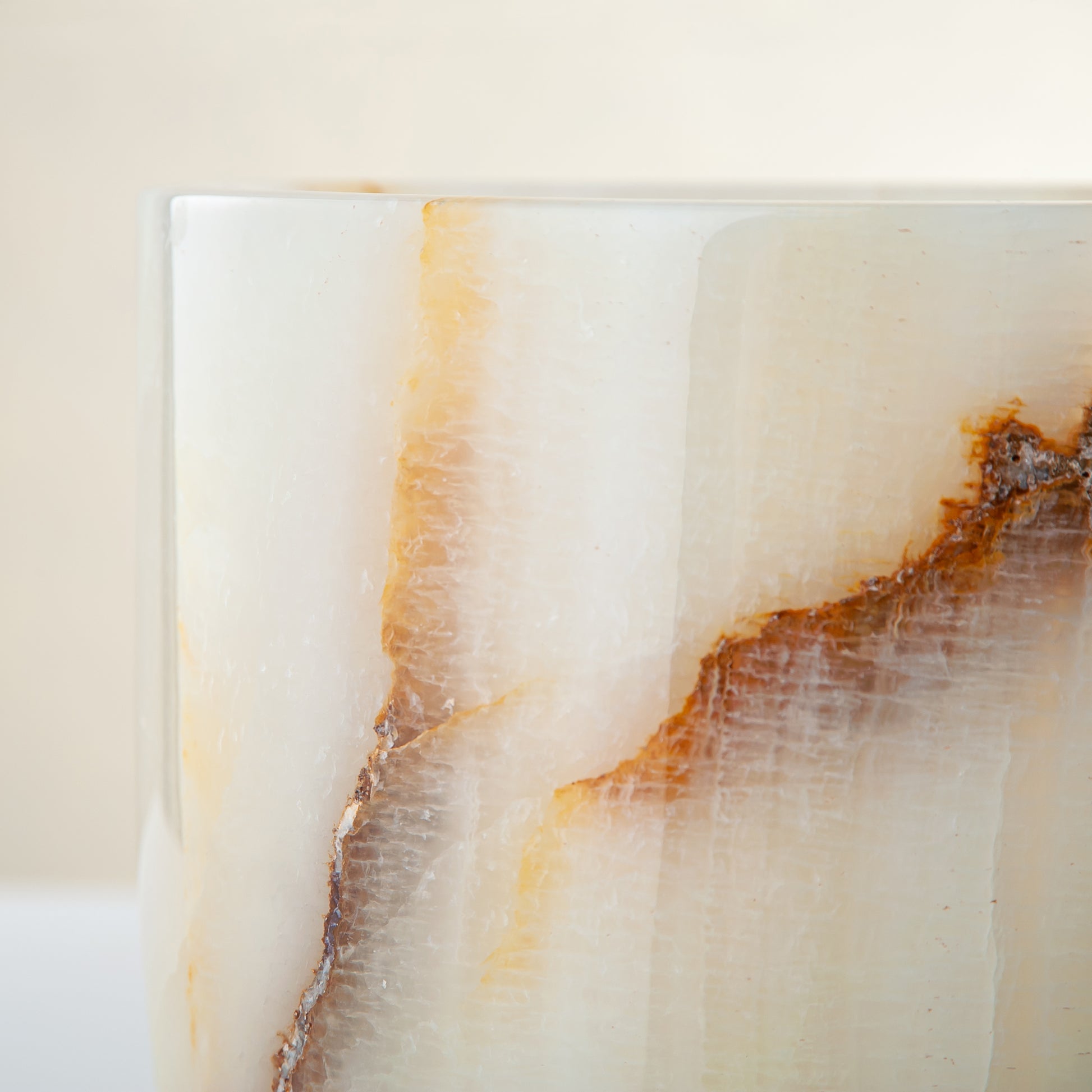 handcrafted onyx vase with ivory base and bold brown veining for modern decor
