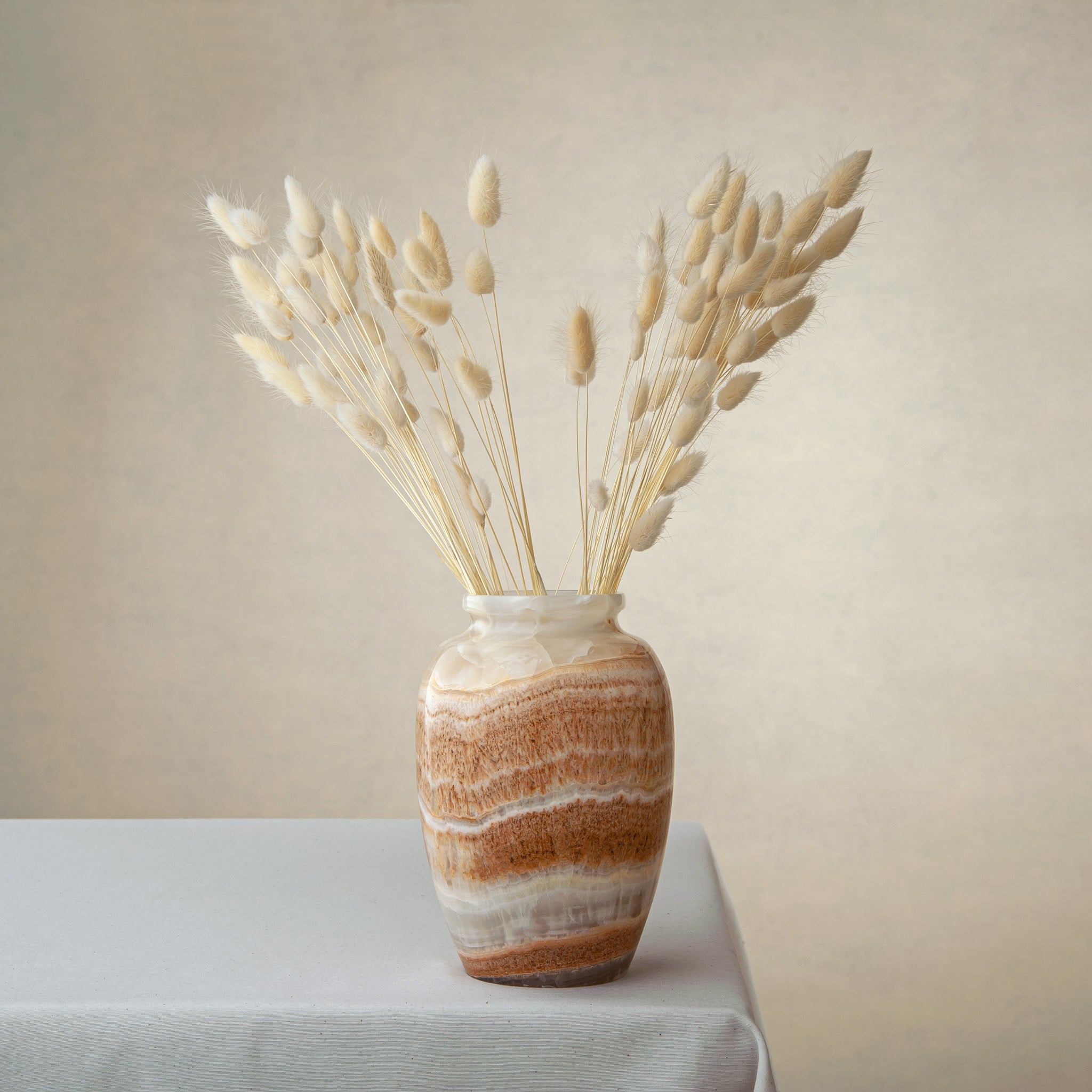 handcrafted onyx vase with terracotta and ivory banding for warm interior decor
