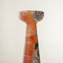 handcrafted orange onyx candle holder with tall sculptural form and translucent veining for modern decor
