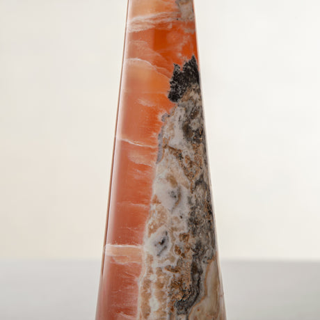 handcrafted orange onyx candle holder with tall sculptural form and translucent veining for modern decor
