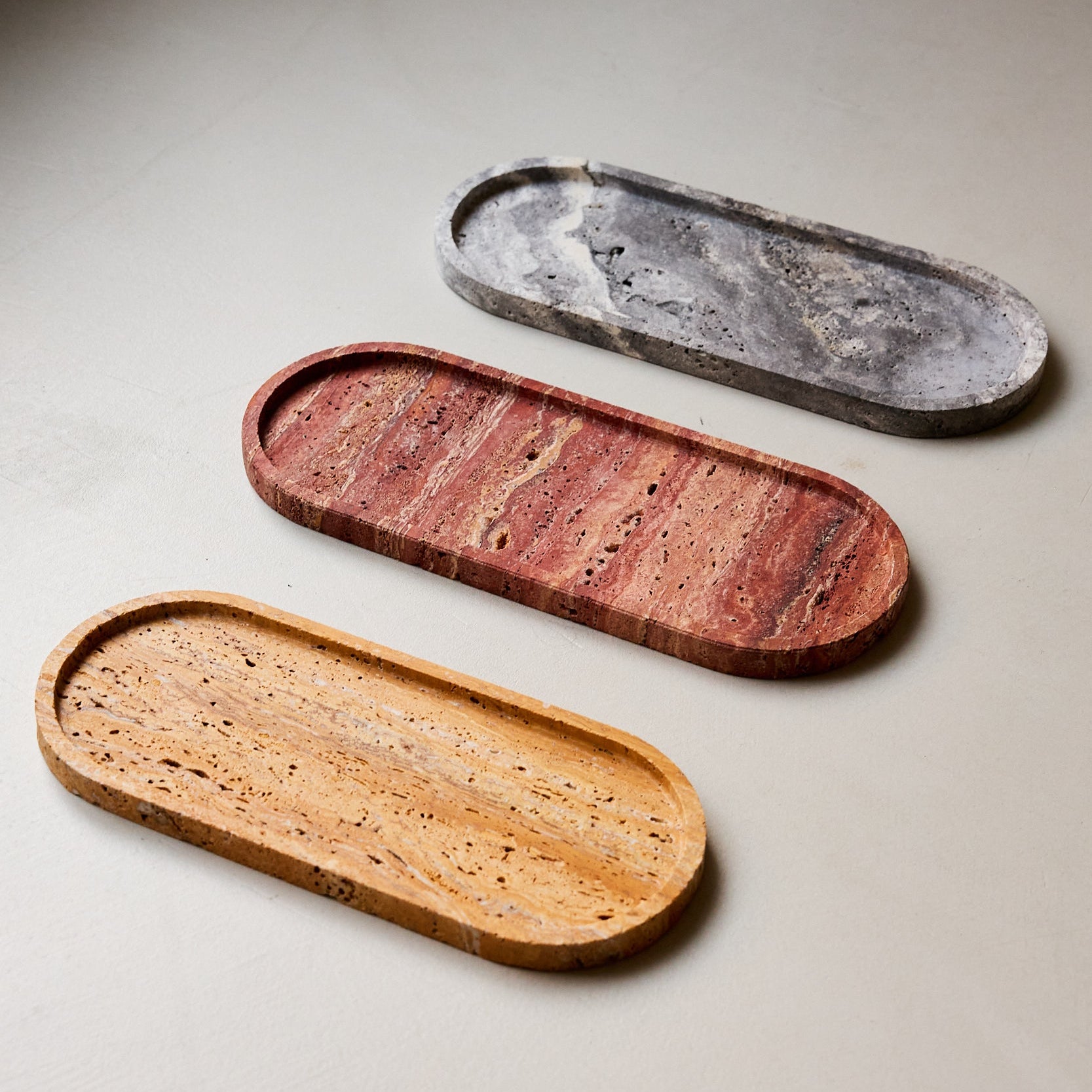 Unique orange travertine tray with natural veining and handcrafted curved design
