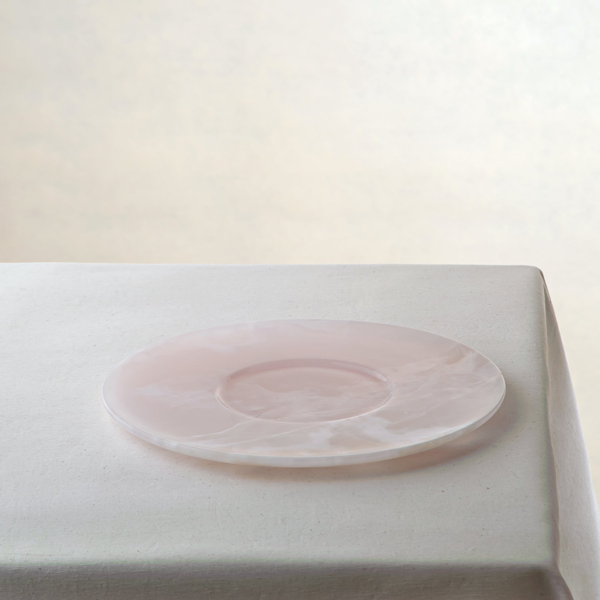 handcrafted pink onyx plate with smooth round shape and soft blush tones for modern table decor
