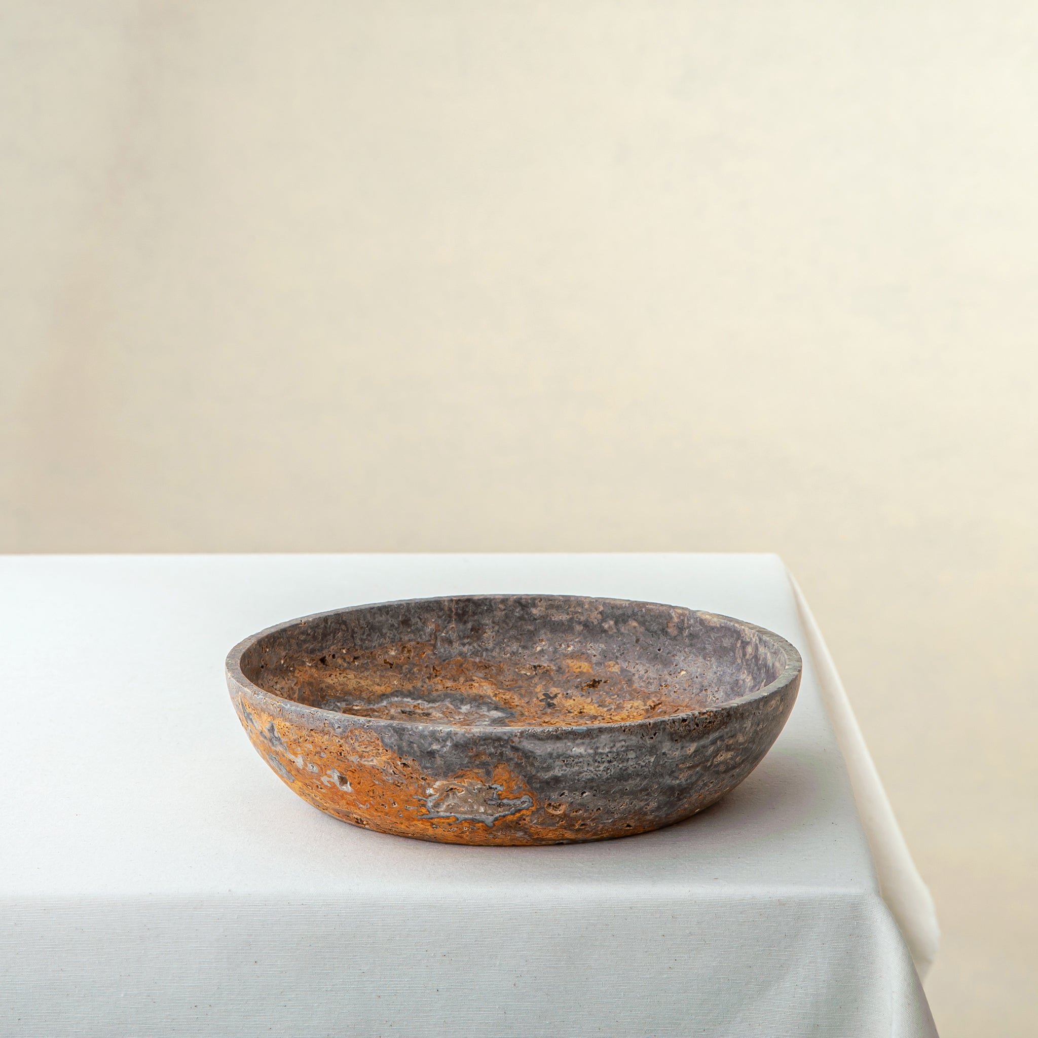 handcrafted travertine bowl with rustic texture and warm earthy tones for table decor

