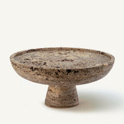 handcrafted travertine cake stand with porous texture and pedestal base for centerpiece display
