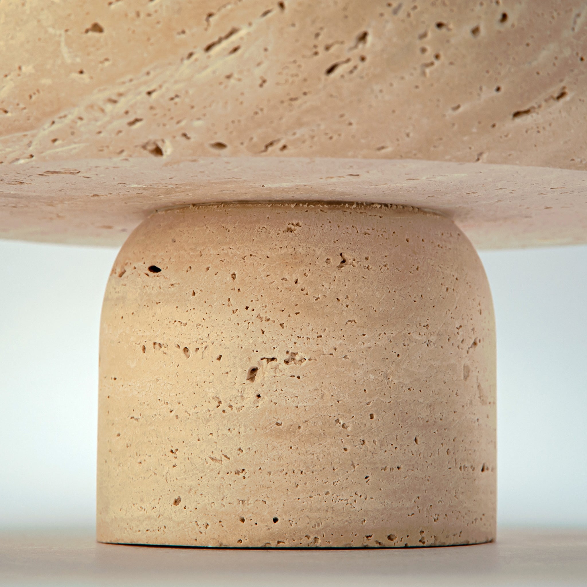 handcrafted travertine pedestal bowl made from natural stone with porous texture