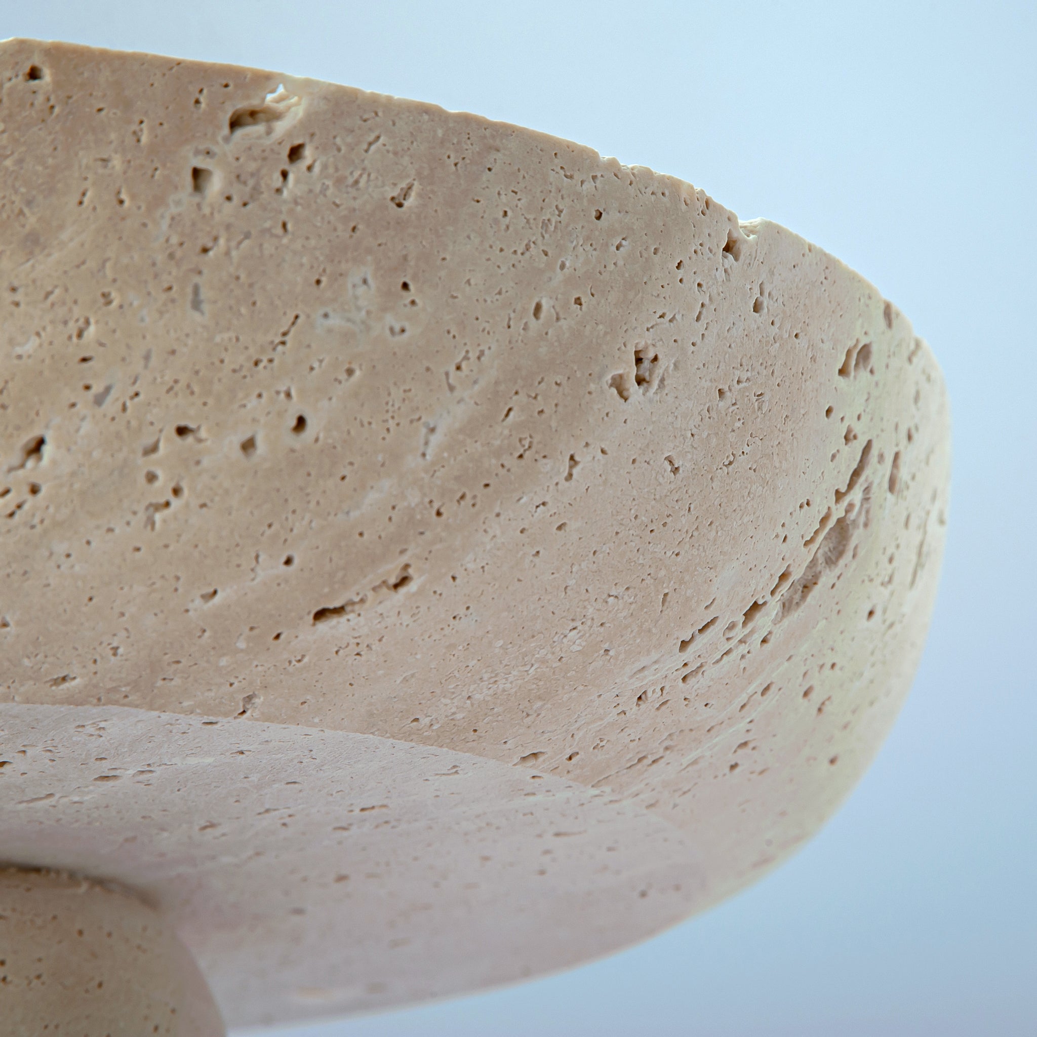 handcrafted travertine pedestal bowl made from natural stone with porous texture