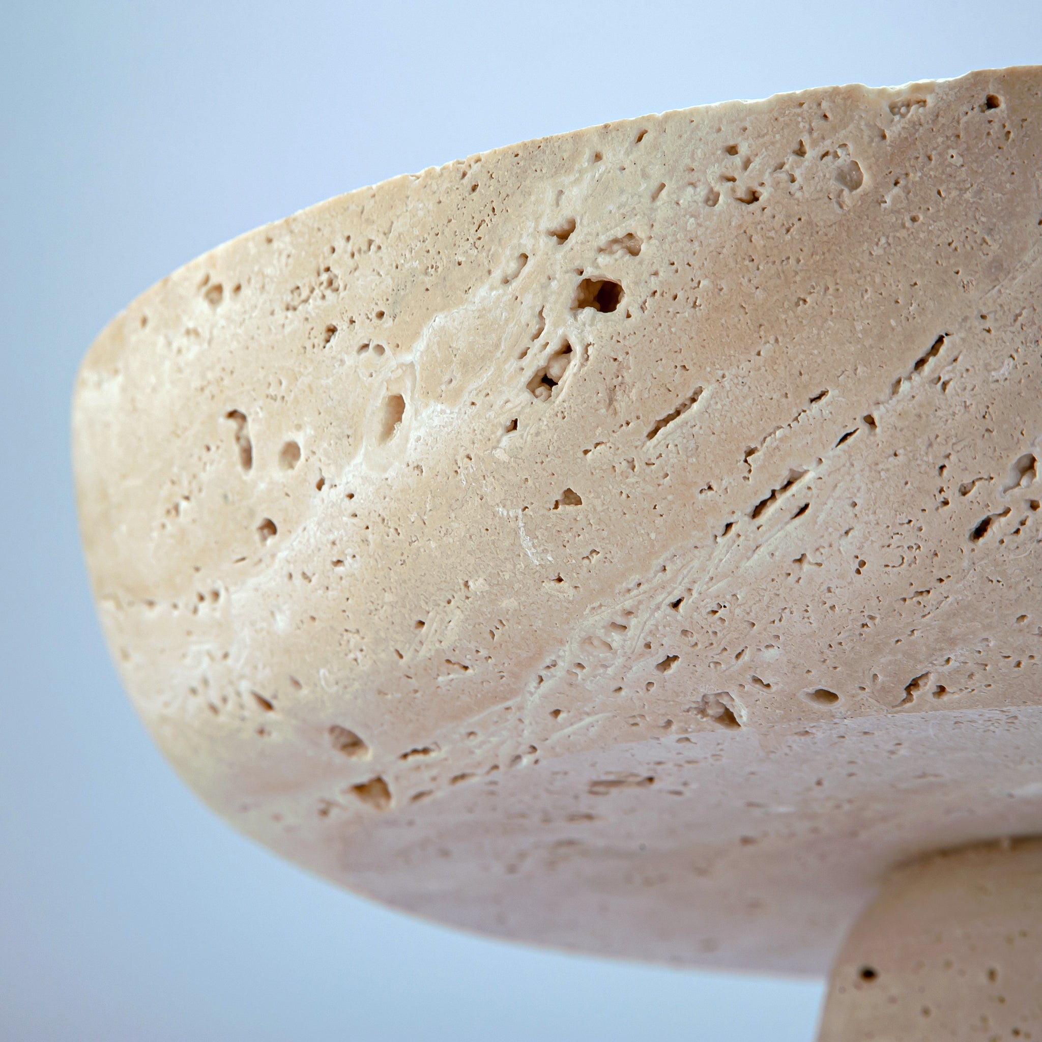 handcrafted travertine pedestal bowl made from natural stone with porous texture