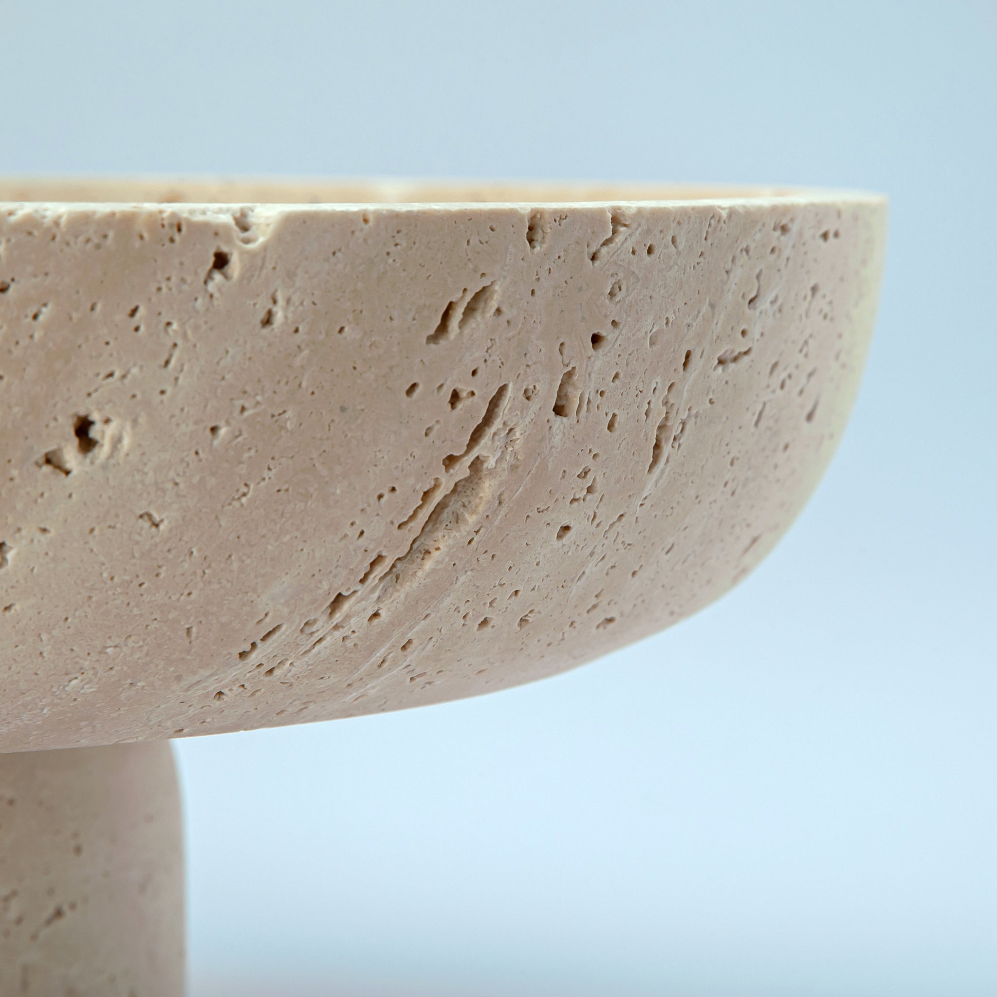 handcrafted travertine pedestal bowl made from natural stone with porous texture