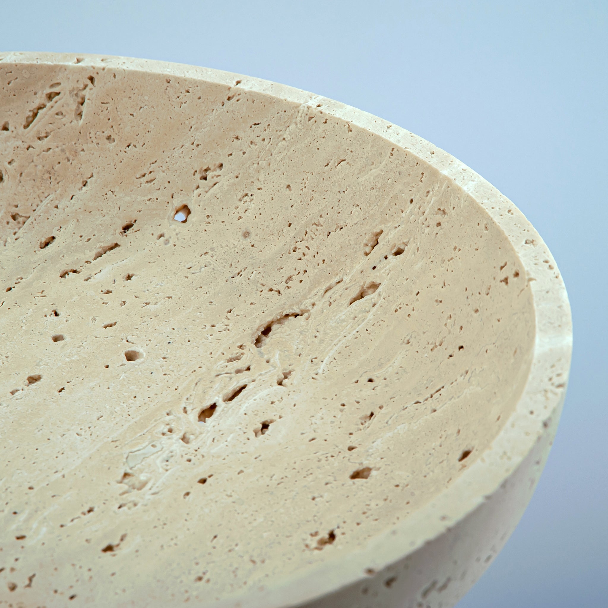 handcrafted travertine pedestal bowl made from natural stone with porous texture
