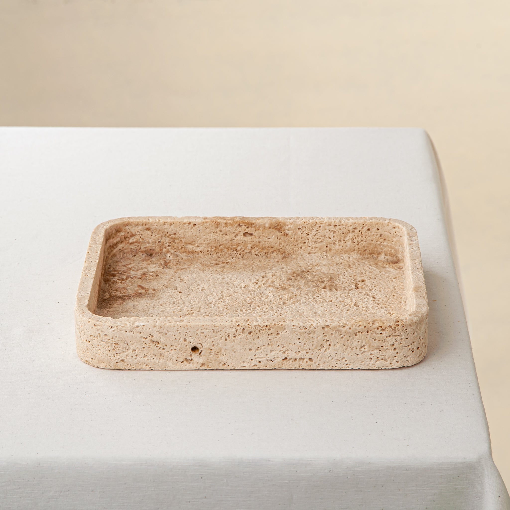 handcrafted travertine tray with porous texture and beige tones for modern decor
