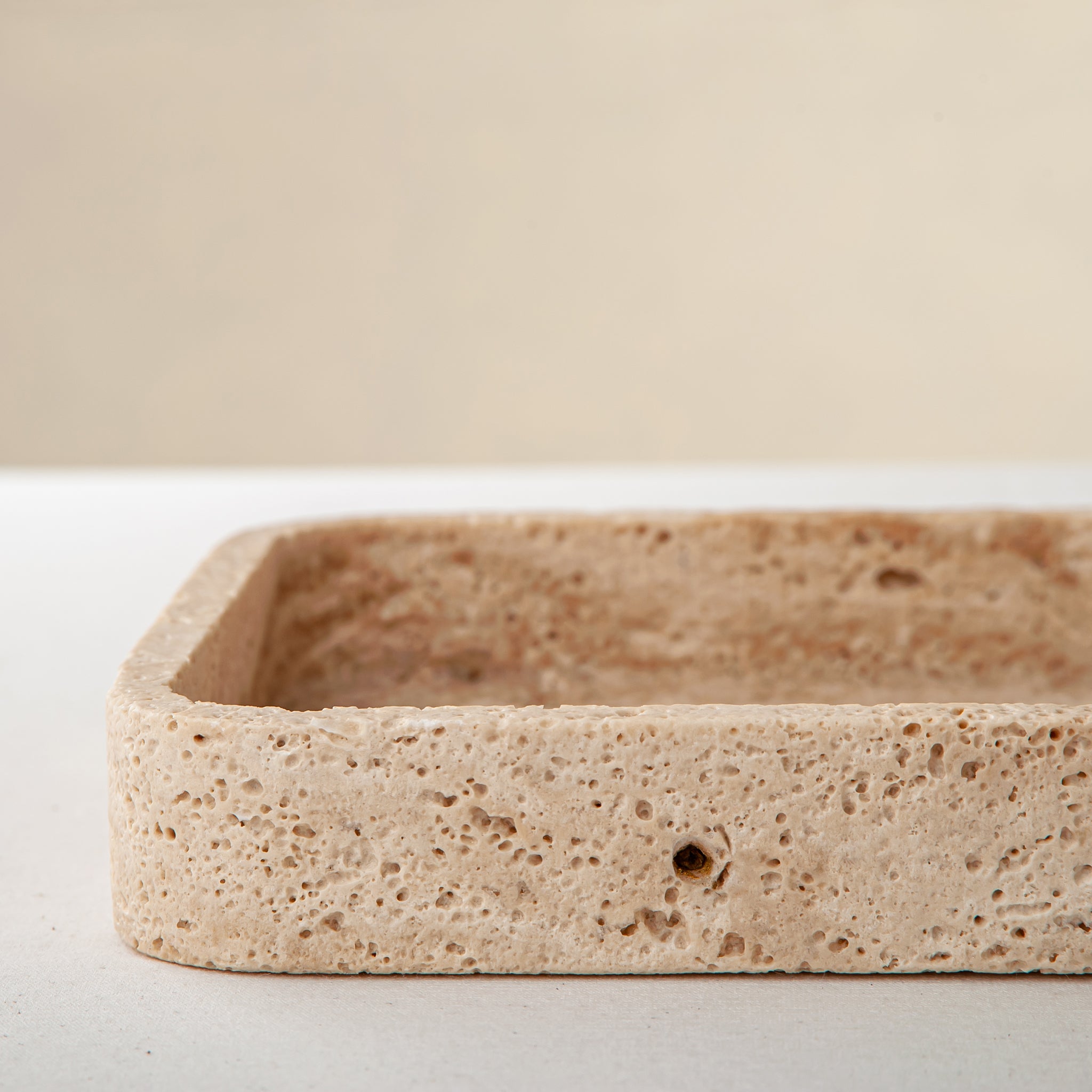 handcrafted travertine tray with porous texture and beige tones for modern decor
