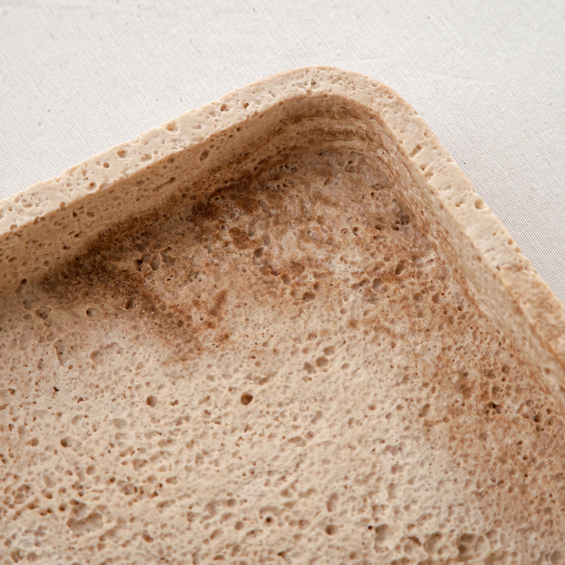 handcrafted travertine tray with porous texture and beige tones for modern decor
